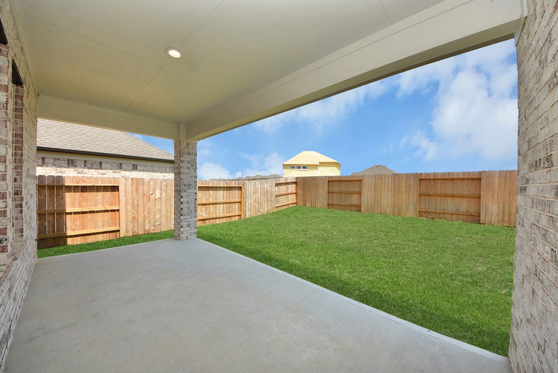 63 Knight Bayou Drive, Dayton, TX 77535 Experience outdoor living at its finest on this expansive covered patio, thoughtfully designed for BBQs and delightful outdoor dining.
