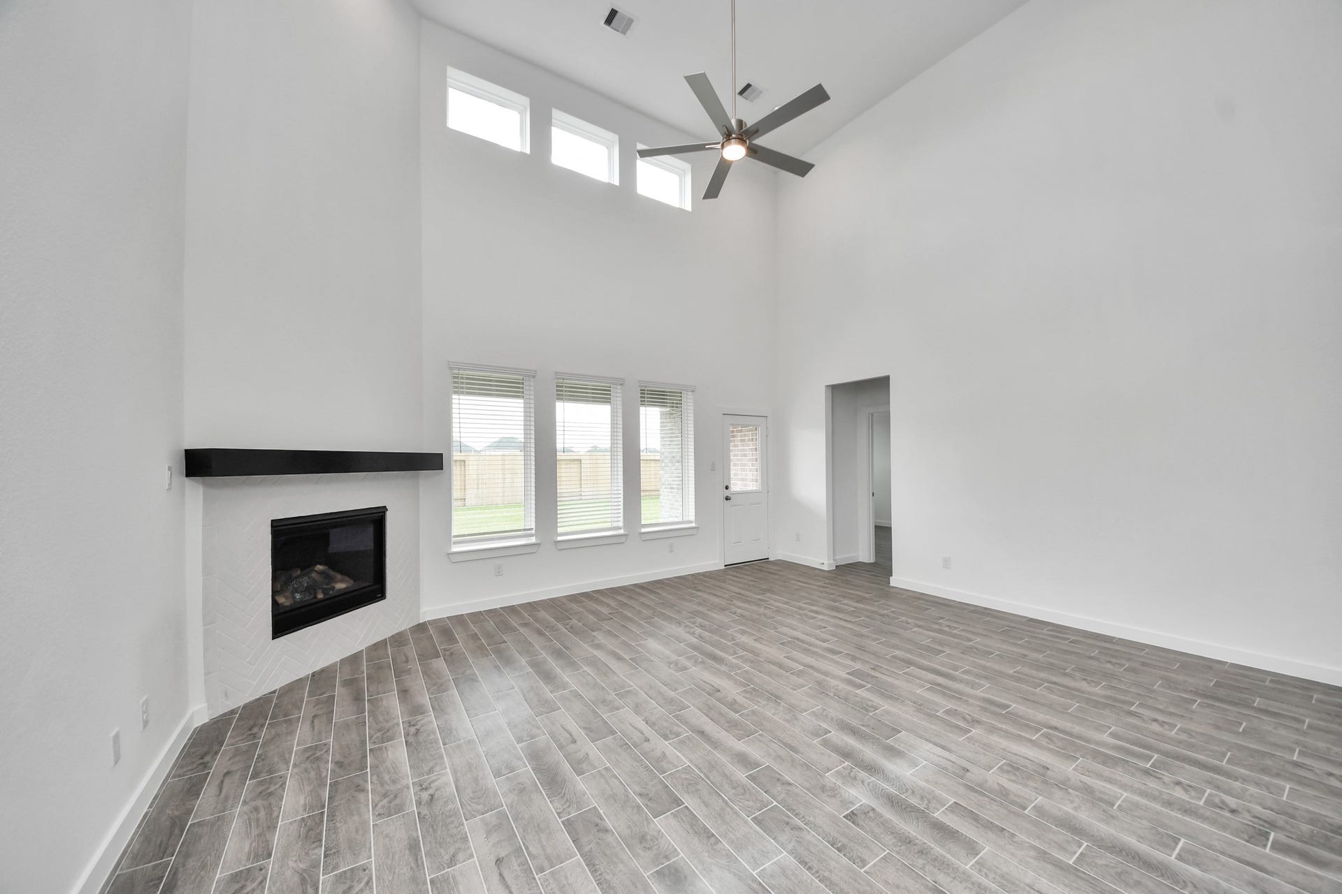 63 Knight Bayou Drive, Dayton, TX 77535 Welcome family and guests to your charming living room! With its high ceilings, recessed lighting, ceiling fan, custom paint, beautiful flooring, and large windows that let in abundant natural light, this room is perfect for gatherings. Sample photo of completed home with similar floor plan. Actual colors and selections may vary.