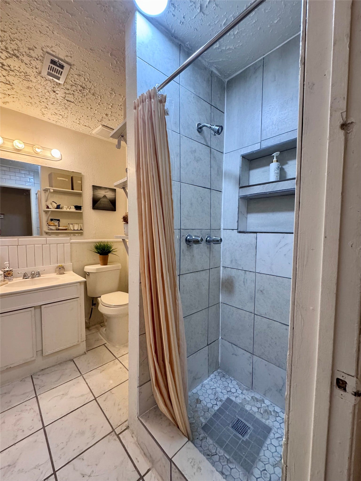 The secondary bathroom has a walk-in shower.