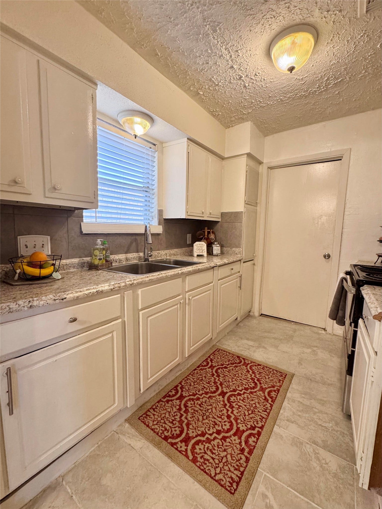 The kitchen leads to the garage.
