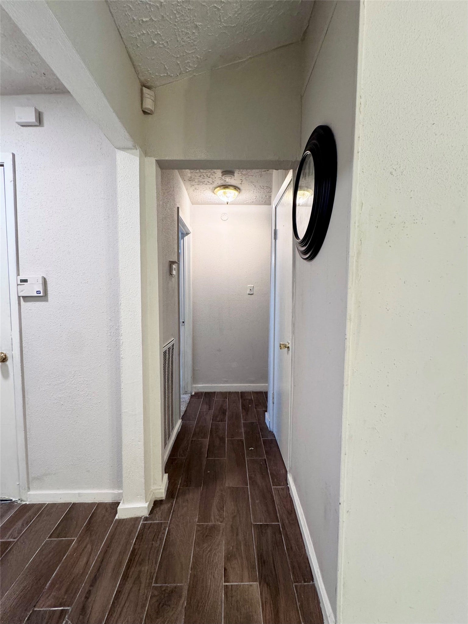 This hallway leads to the secondary bathroom and all bedrooms.