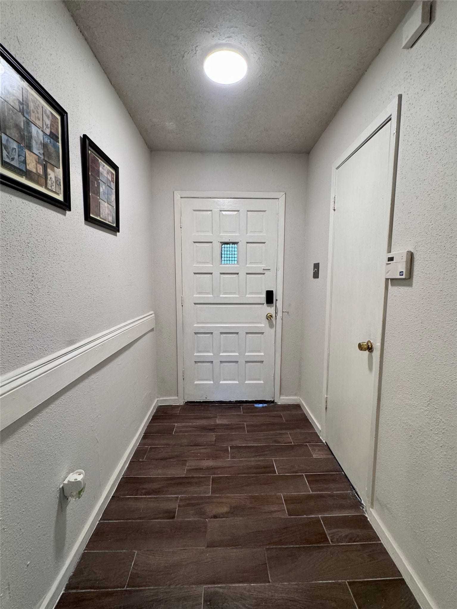 A view of the front door and foyer from the interior of the home.