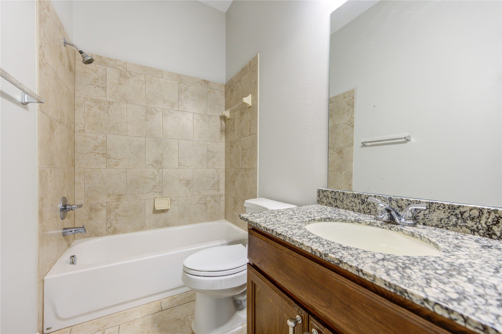27407 Gatlin Lane, Spring, TX 77386 Luxurious bathroom with a soaking tub, granite vanity, and tiled surround. Your own private spa awaits.