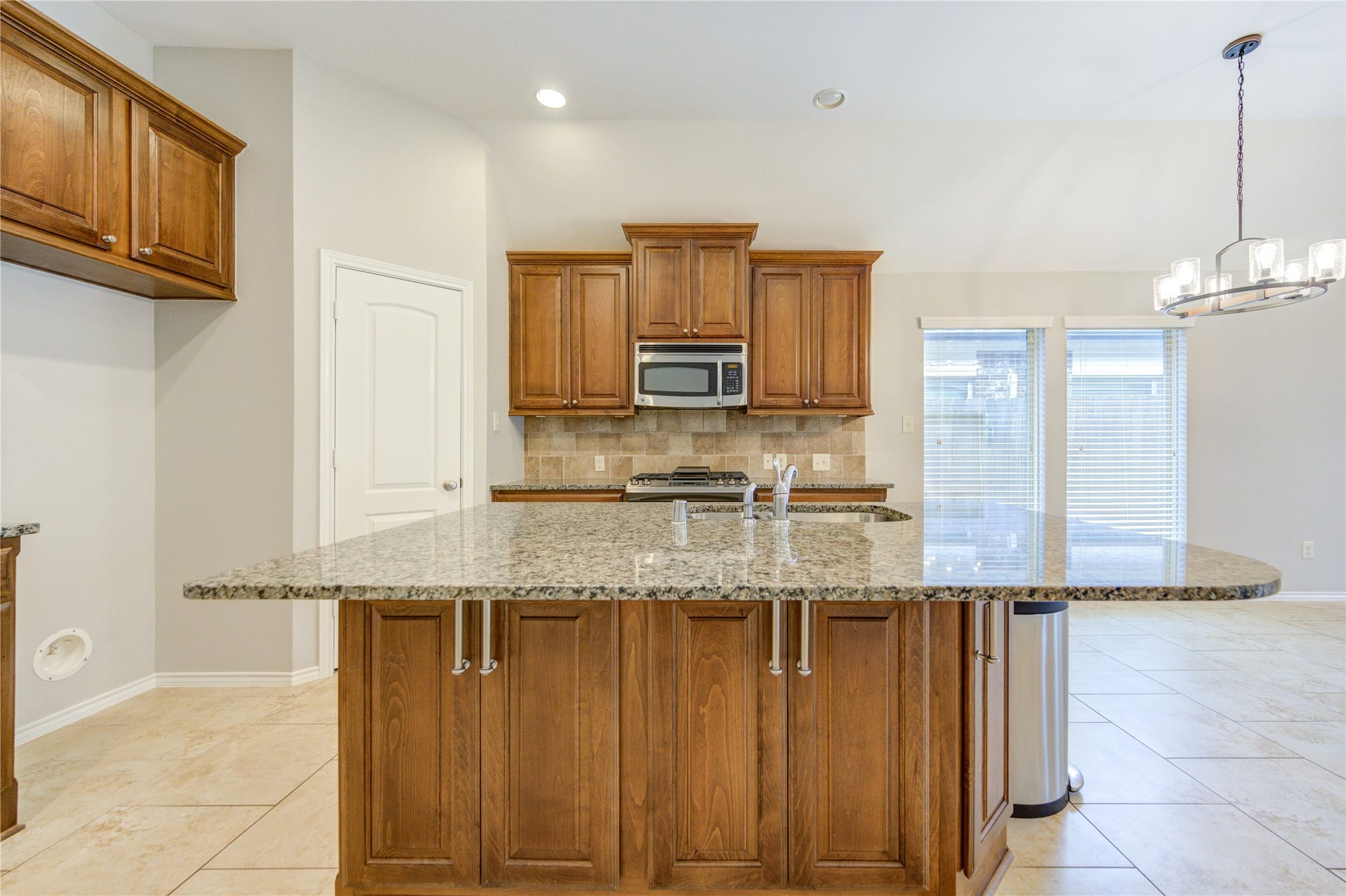 27407 Gatlin Lane, Spring, TX 77386 Gourmet kitchen with granite countertops and custom wood cabinetry. A dream space for any home chef.