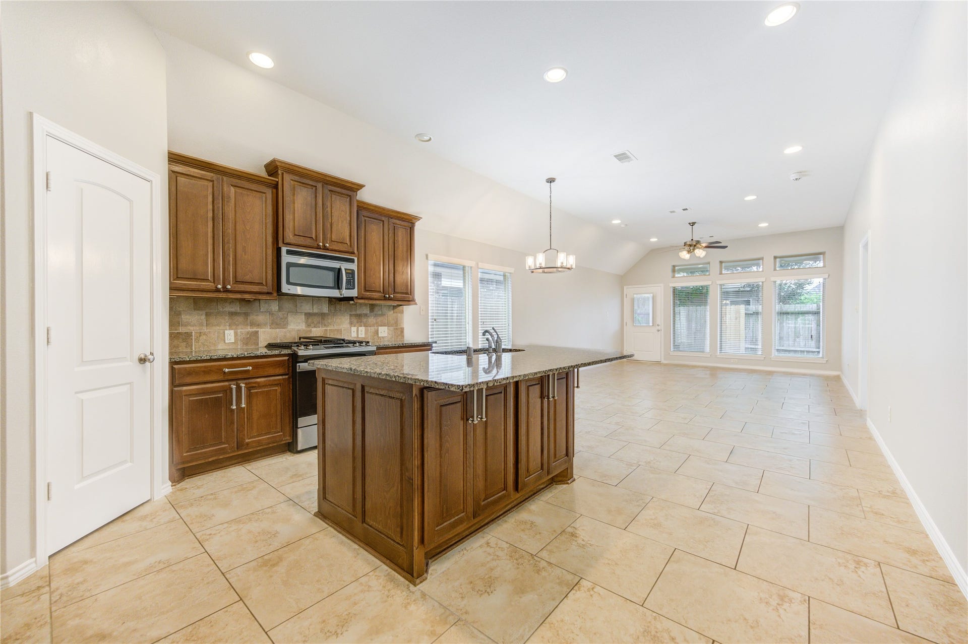 27407 Gatlin Lane, Spring, TX 77386 Second kitchen view highlights a generous island and tile flooring, perfect for casual meals. Function meets style effortlessly.