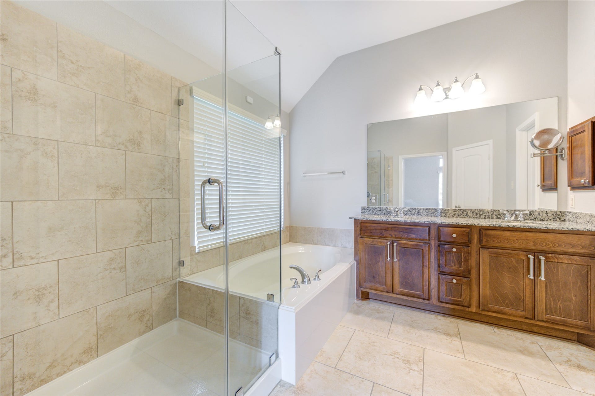 27407 Gatlin Lane, Spring, TX 77386 Elegant bathroom with double vanity and a tiled walk-in shower. Designed for everyday indulgence.