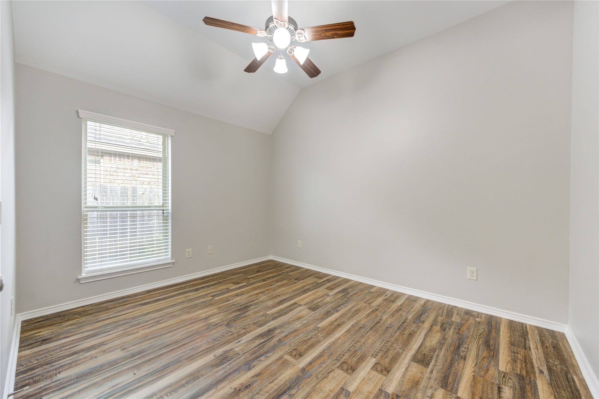27407 Gatlin Lane, Spring, TX 77386 Airy bedroom with wood-look vinyl plank flooring and a ceiling fan for year-round comfort. Simple, bright, and inviting.