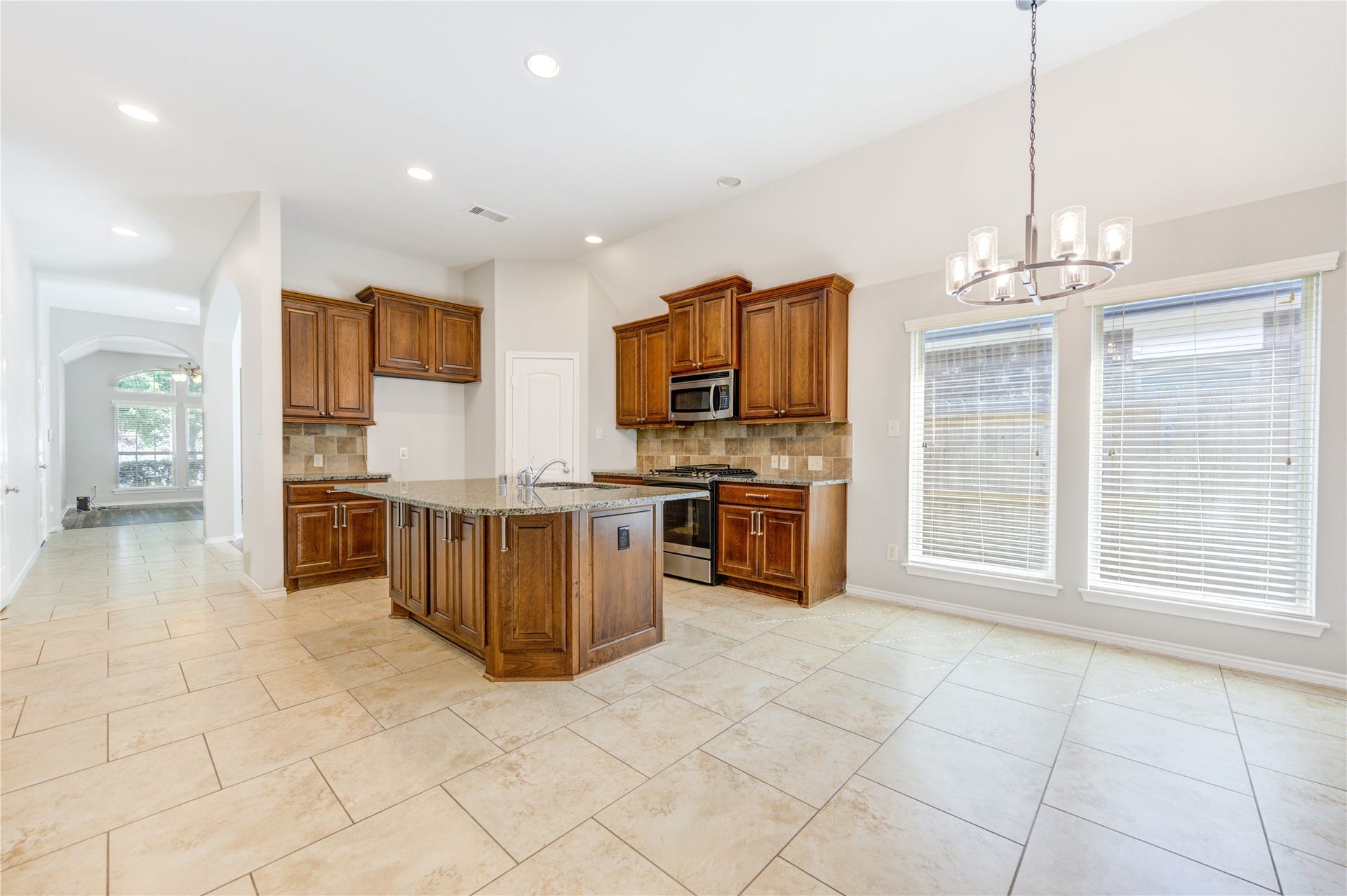 27407 Gatlin Lane, Spring, TX 77386 Bright kitchen bathed in natural light with classic wood cabinetry. Comfort and charm in every corner.