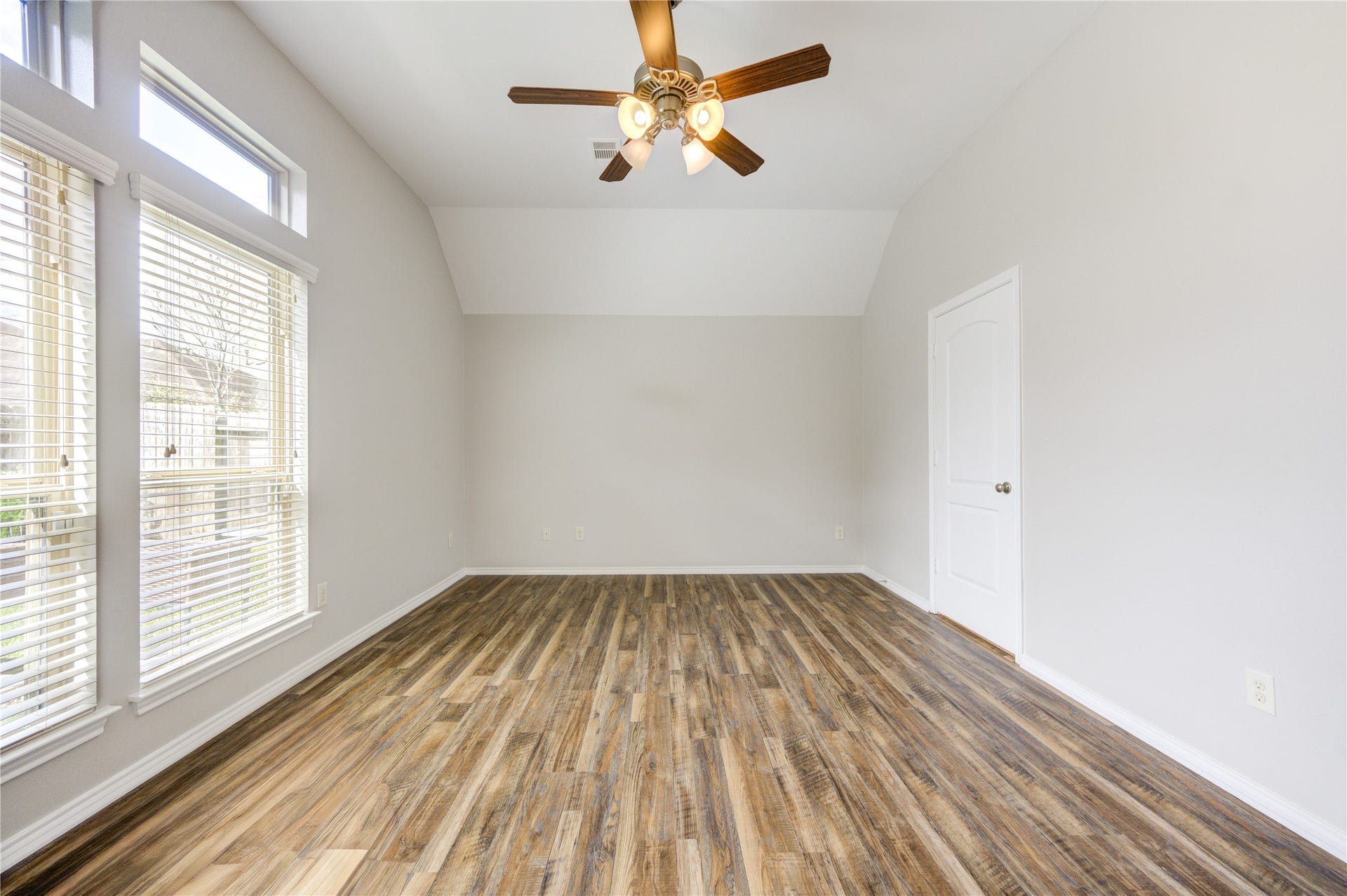 27407 Gatlin Lane, Spring, TX 77386 Serene bedroom with wood-look vinyl plank flooring, ceiling fan, and natural light. A peaceful escape to call your own.