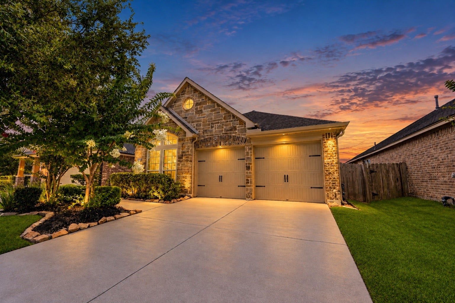 27407 Gatlin Lane, Spring, TX 77386 Twilight exterior showcases this charming home with warm lighting and a spacious 2-car garage. A picture-perfect curb appeal that makes a lasting first impression.
