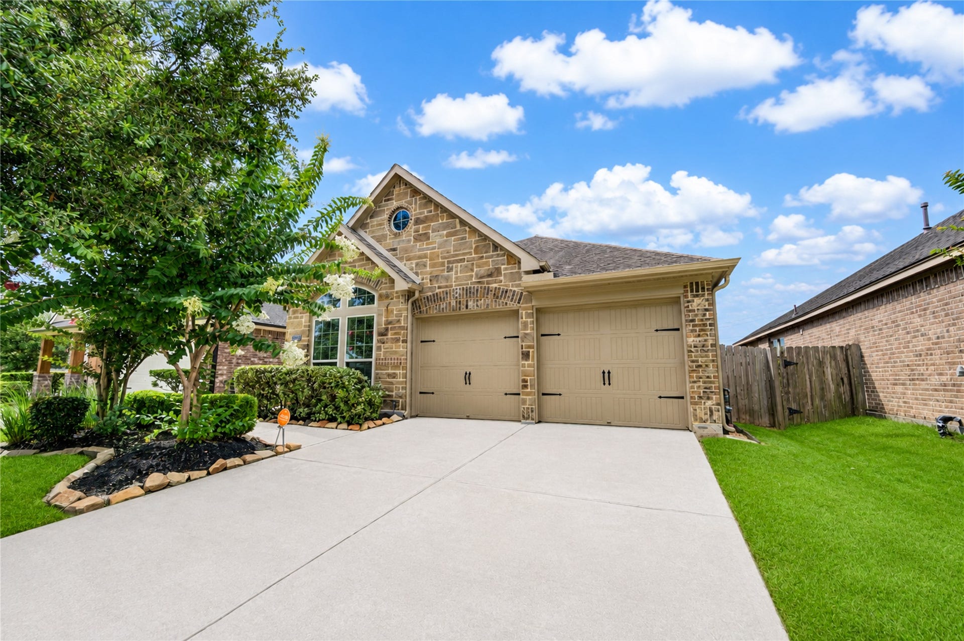 27407 Gatlin Lane, Spring, TX 77386 Charming daytime front view with manicured landscaping and classic stone-and-siding exterior. Pride of ownership shows at every turn.