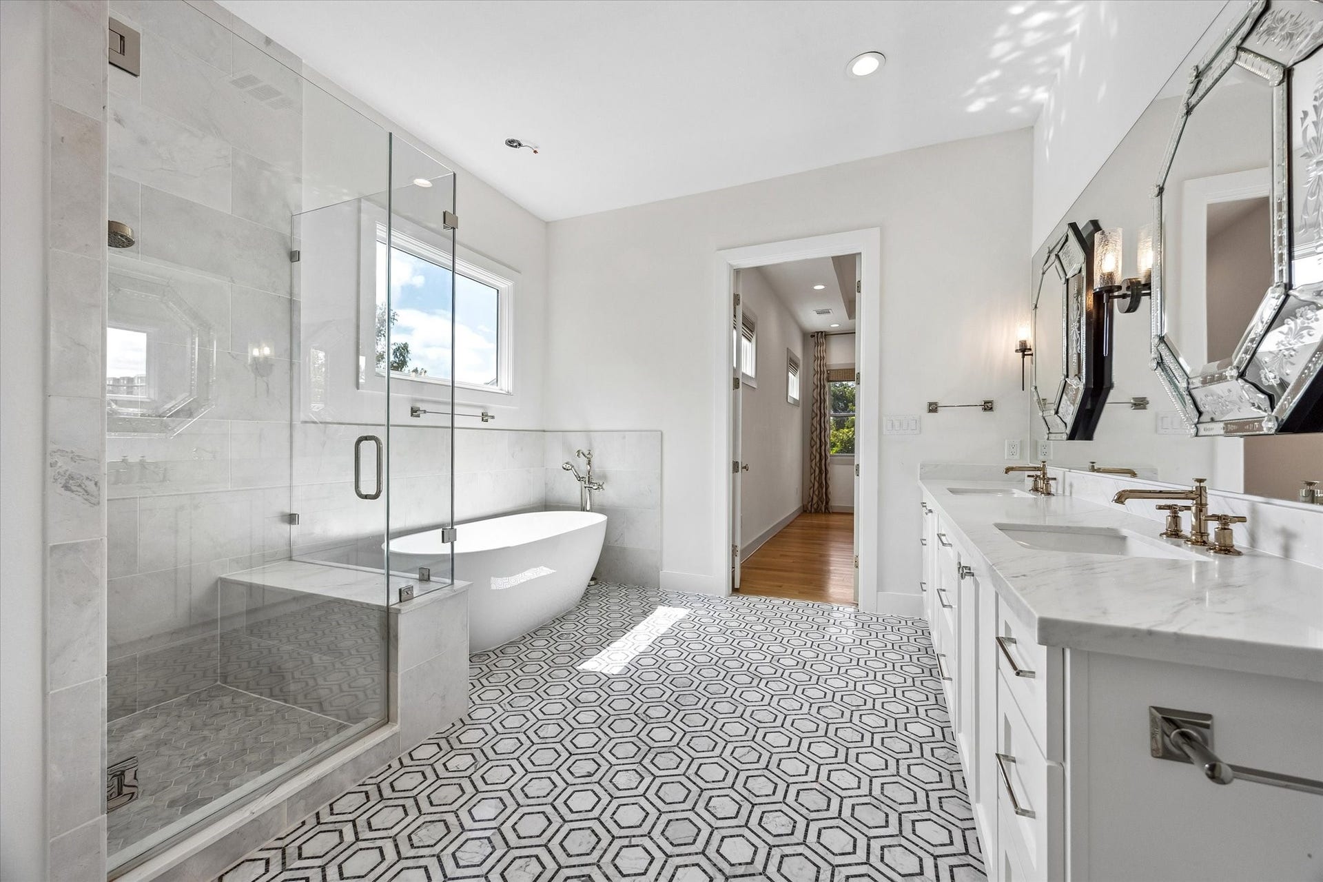 704 Teetshorn Street, Houston, TX 77009 Another view of the primary bath showcases the glass-enclosed shower, soaking tub and generous vanity space.