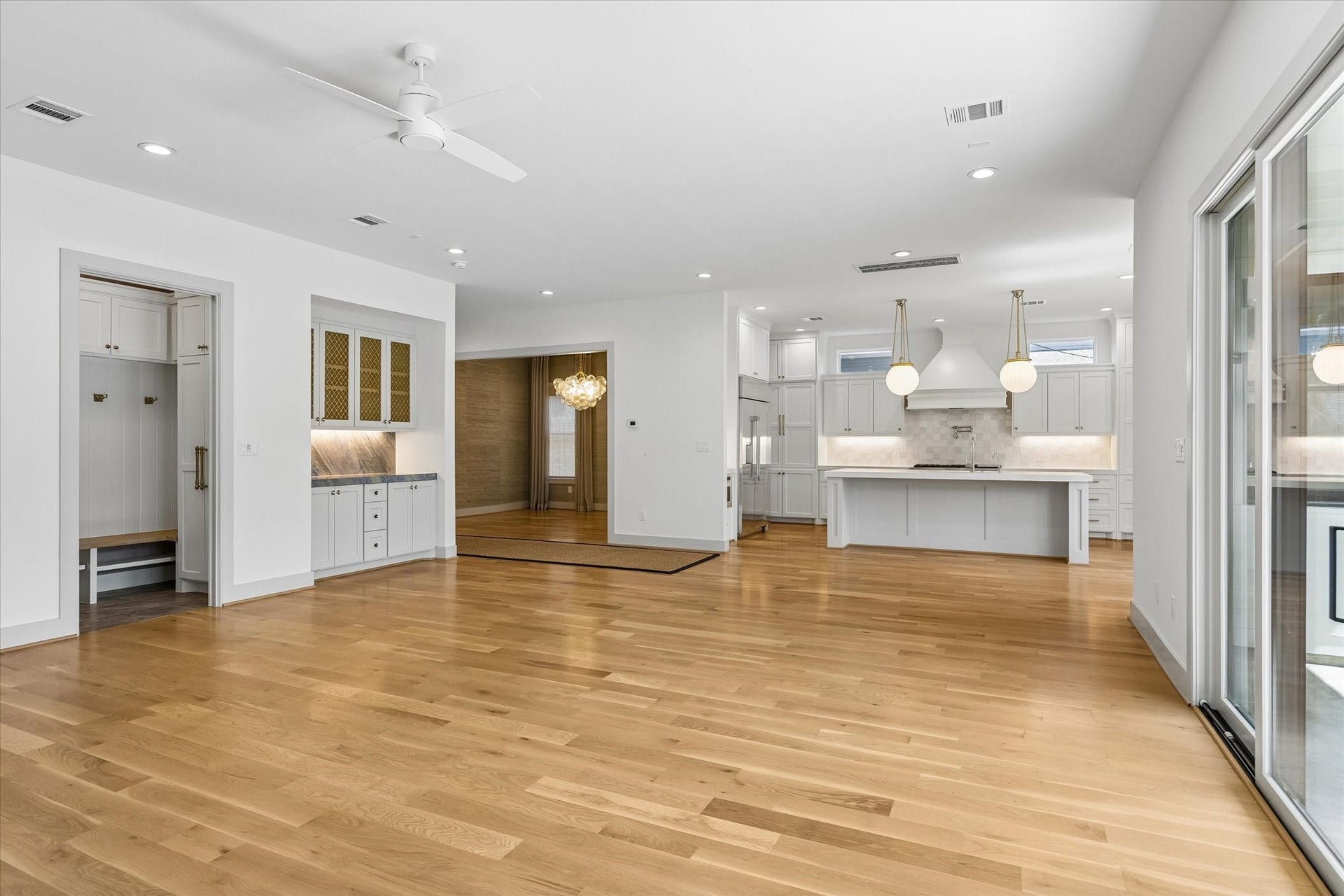 704 Teetshorn Street, Houston, TX 77009 The living area opens seamlessly to the kitchen, with hardwood floors and oversized glass doors overlooking the backyard.