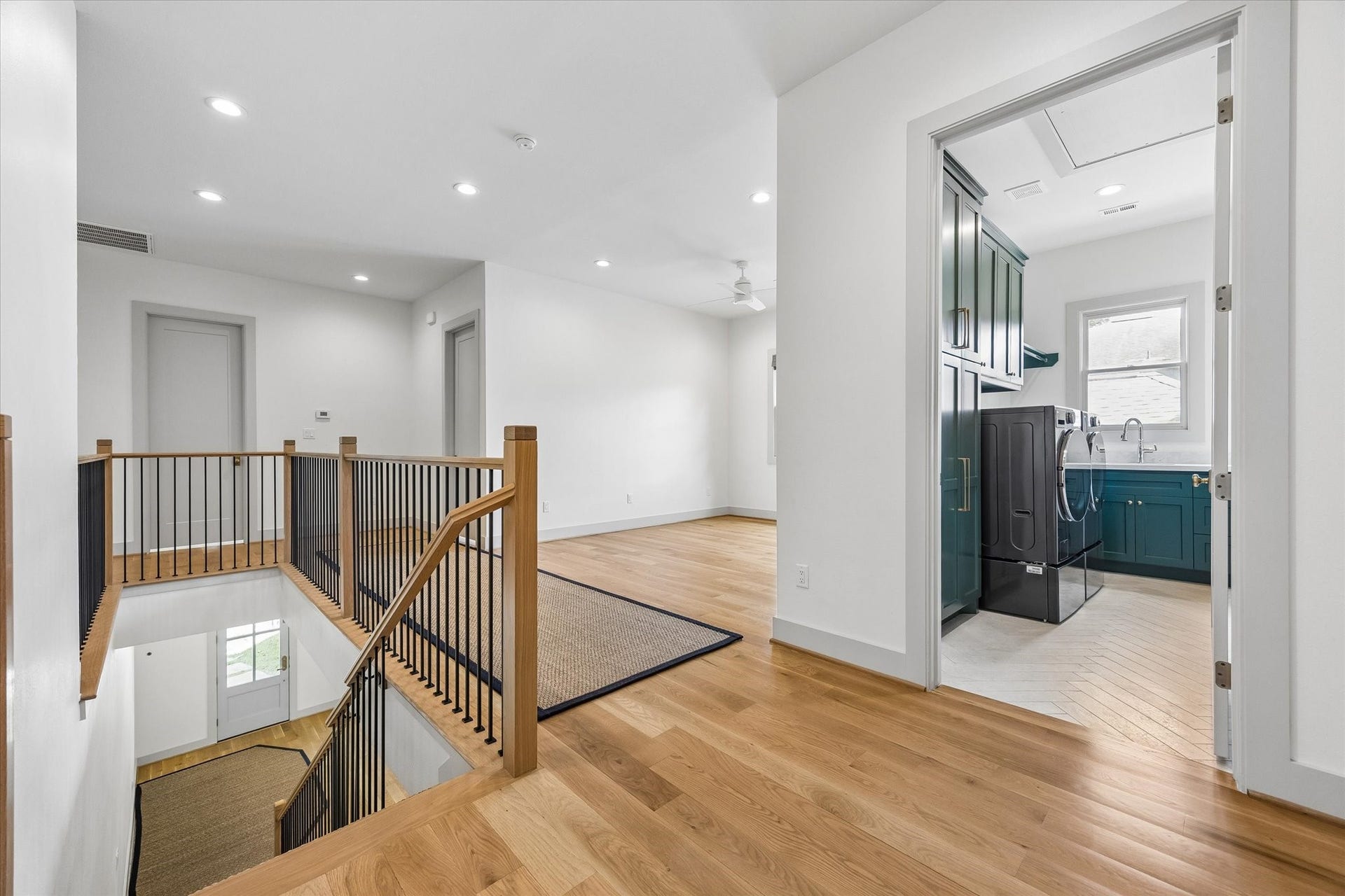 704 Teetshorn Street, Houston, TX 77009 An airy second-floor hall wraps around the open staircase, creating a bright connection between the game room and bedroom suites.
