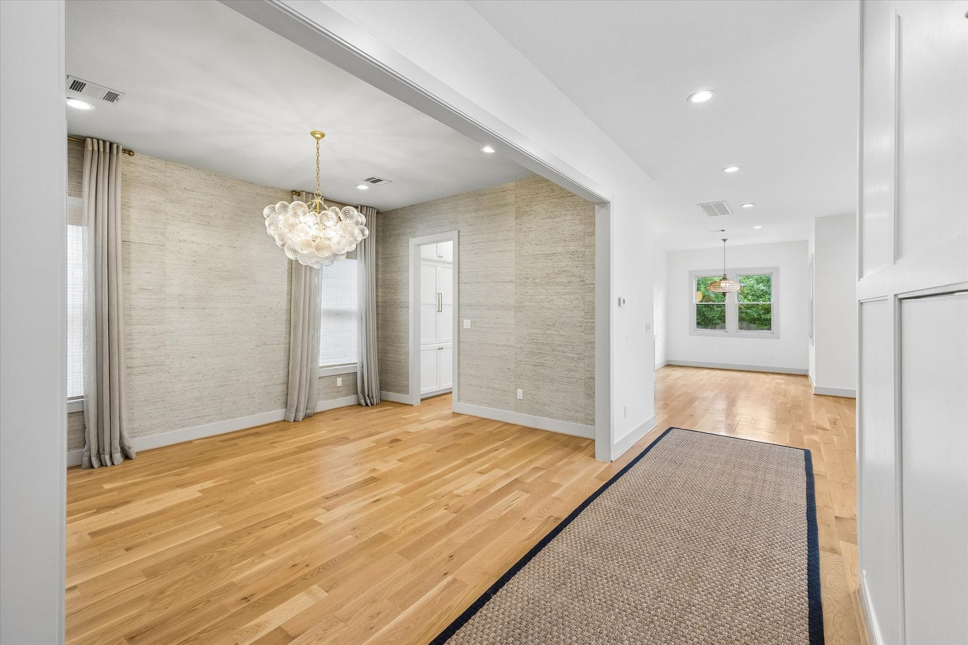 704 Teetshorn Street, Houston, TX 77009 A long central hallway introduces the homes hardwood floors, detailed trimwork and light-filled first-floor layout.