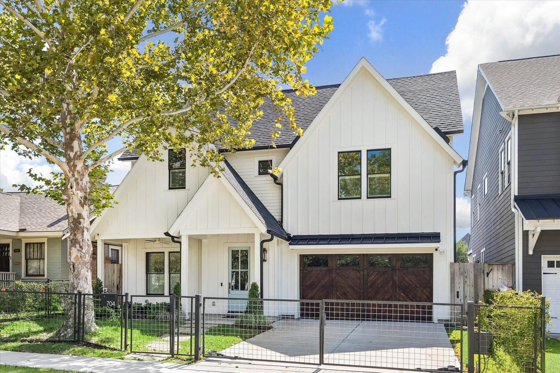 704 Teetshorn Street, Houston, TX 77009 Recent construction in the Heights with a crisp white faade, modern farmhouse-inspired lines and mature tree canopy.