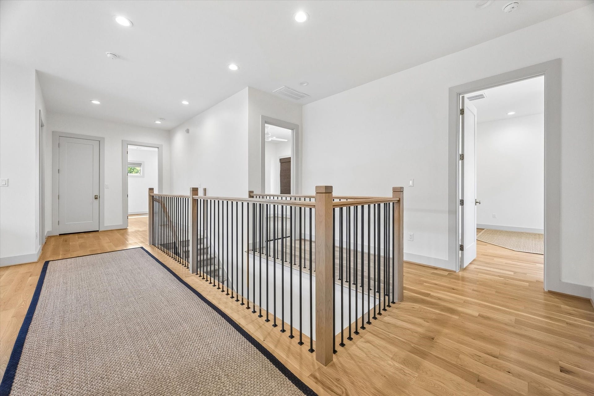 704 Teetshorn Street, Houston, TX 77009 The second floor opens to a spacious landing with hardwood floors, open stair railings and convenient access to the utility room.