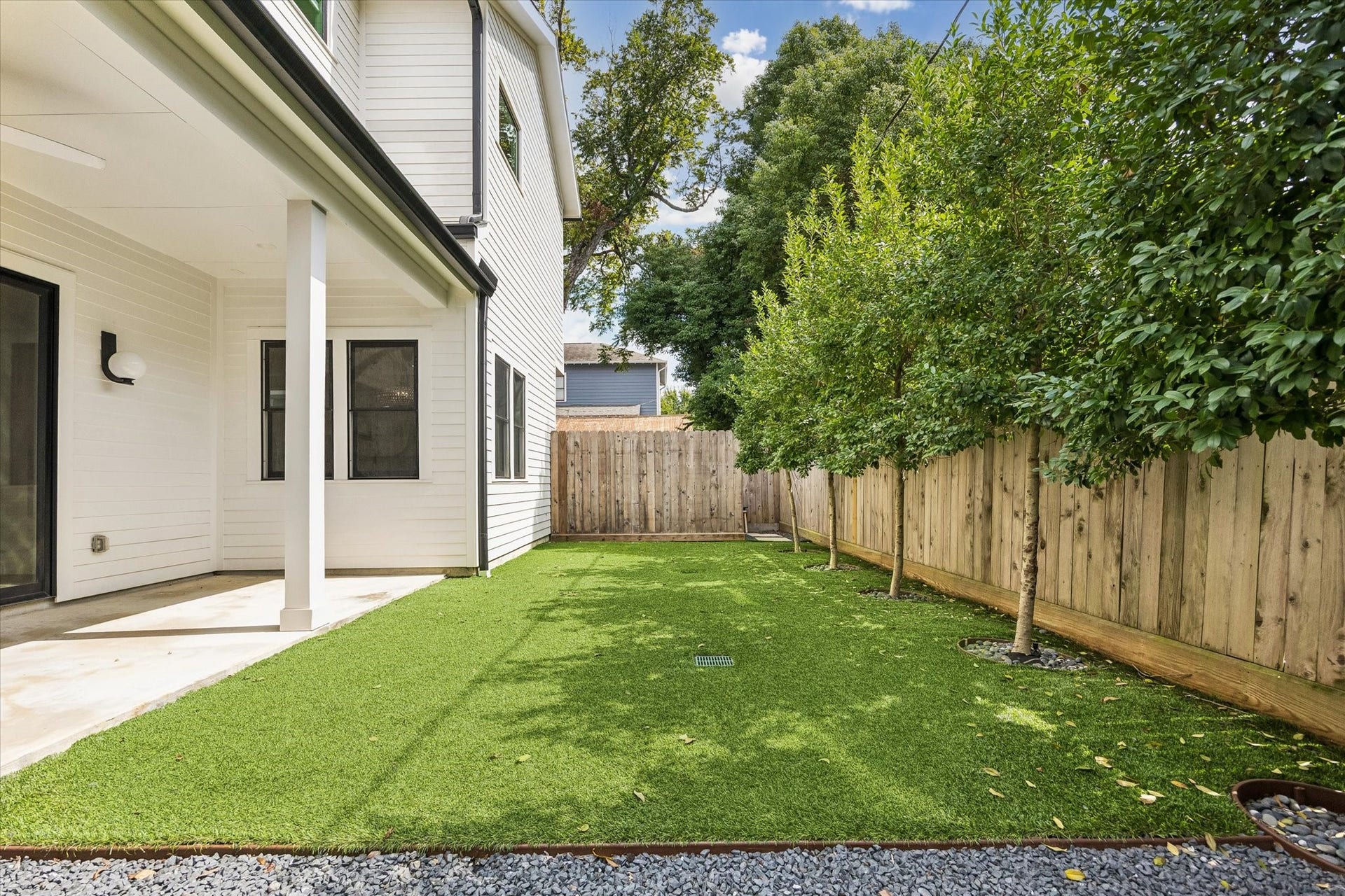704 Teetshorn Street, Houston, TX 77009 Fully fenced backyard with turf, mature landscaping and plenty of room for outdoor play, pets or entertaining.
