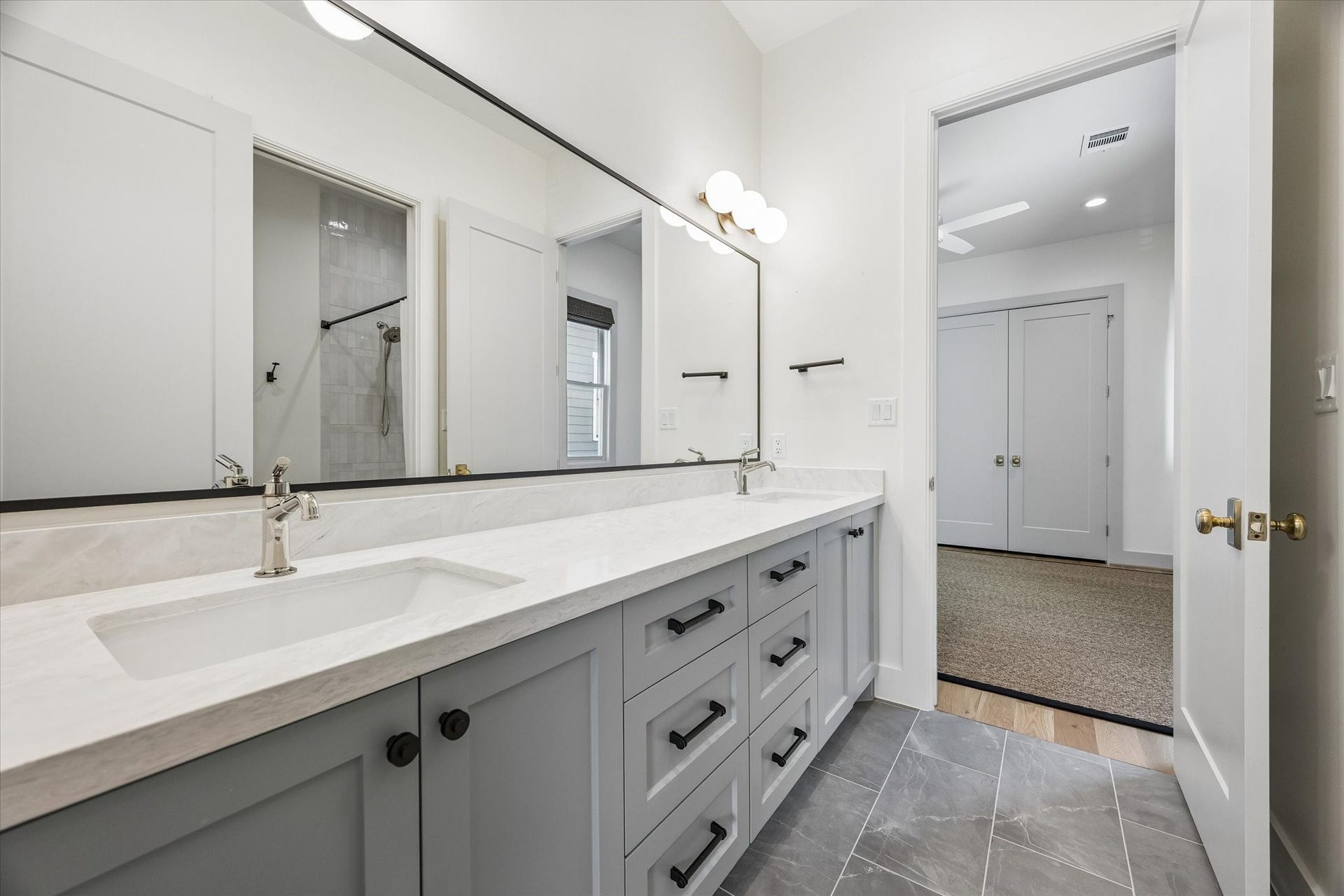 704 Teetshorn Street, Houston, TX 77009 Shared secondary bath with a long vanity, abundant storage and a clean, polished finish.