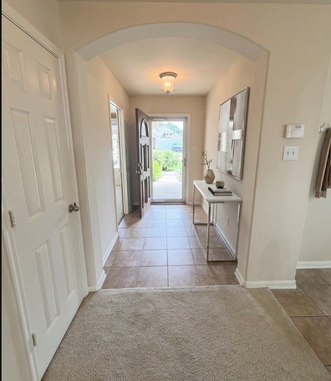 21723 Saragosa Pond Lane, Spring, TX 77379 Inviting entrance with modern tile flooring and elegant lighting, setting the tone for a warm welcome.
