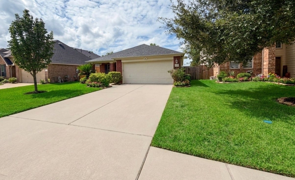 21723 Saragosa Pond Lane, Spring, TX 77379 Charming entrance with pristine lawn and captivating curb appeal.