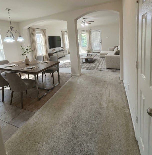 21723 Saragosa Pond Lane, Spring, TX 77379 Experience the seamless flow between the elegantly staged dining and living areas, perfect for modern living and entertaining.