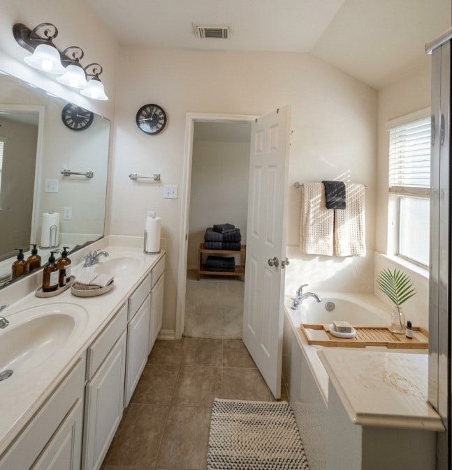 21723 Saragosa Pond Lane, Spring, TX 77379 Luxurious primary bath featuring double sinks, a spacious vanity, and a relaxing soaking tub, beautifully imagined for your comfort.