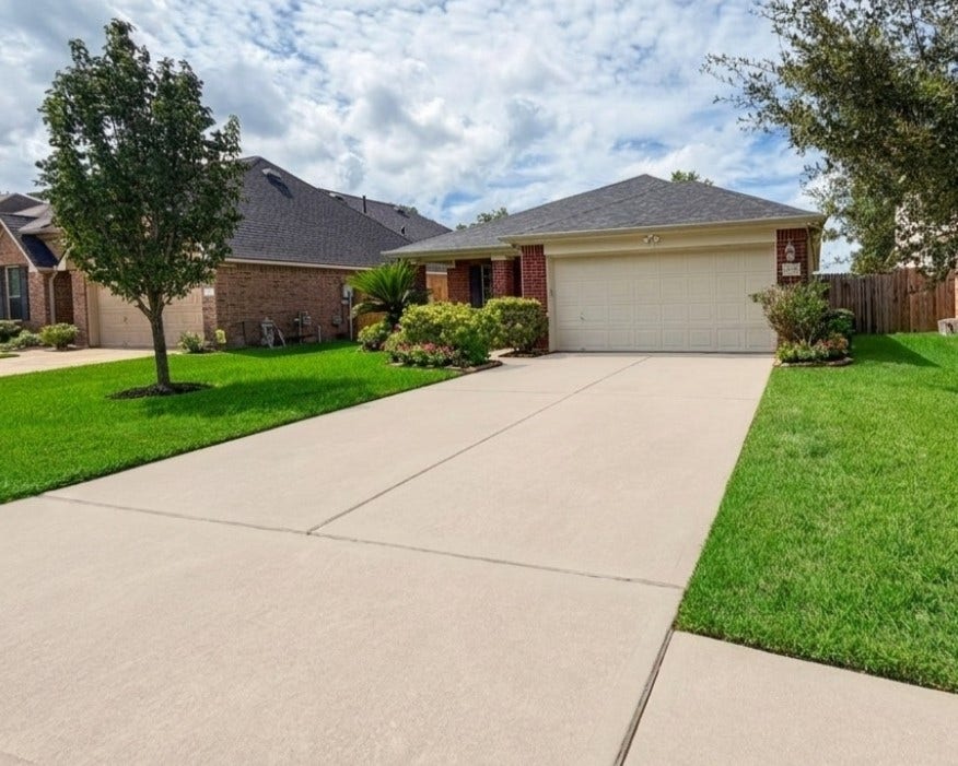 21723 Saragosa Pond Lane, Spring, TX 77379 Charming entrance with pristine lawn and excellent curb appeal.