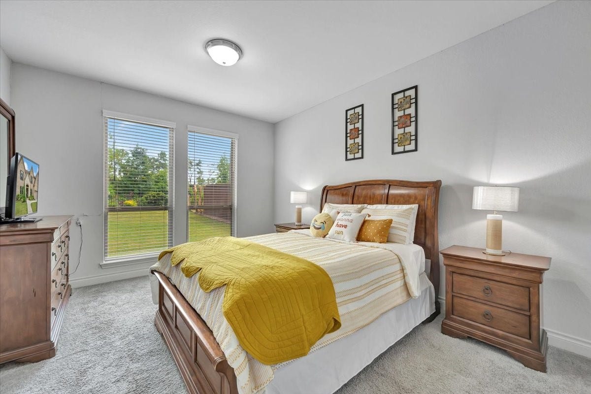 12218 Hickory Arroyo Drive, Humble, TX 77346 Downstairs, discover a cozy additional bedroom with its own private bathroom, offering comfort and convenience for guests or family.