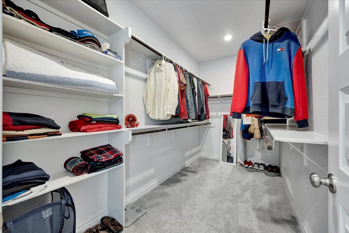 12218 Hickory Arroyo Drive, Humble, TX 77346 Spacious walk-in closet with ample shelving and hanging space for organized storage.
