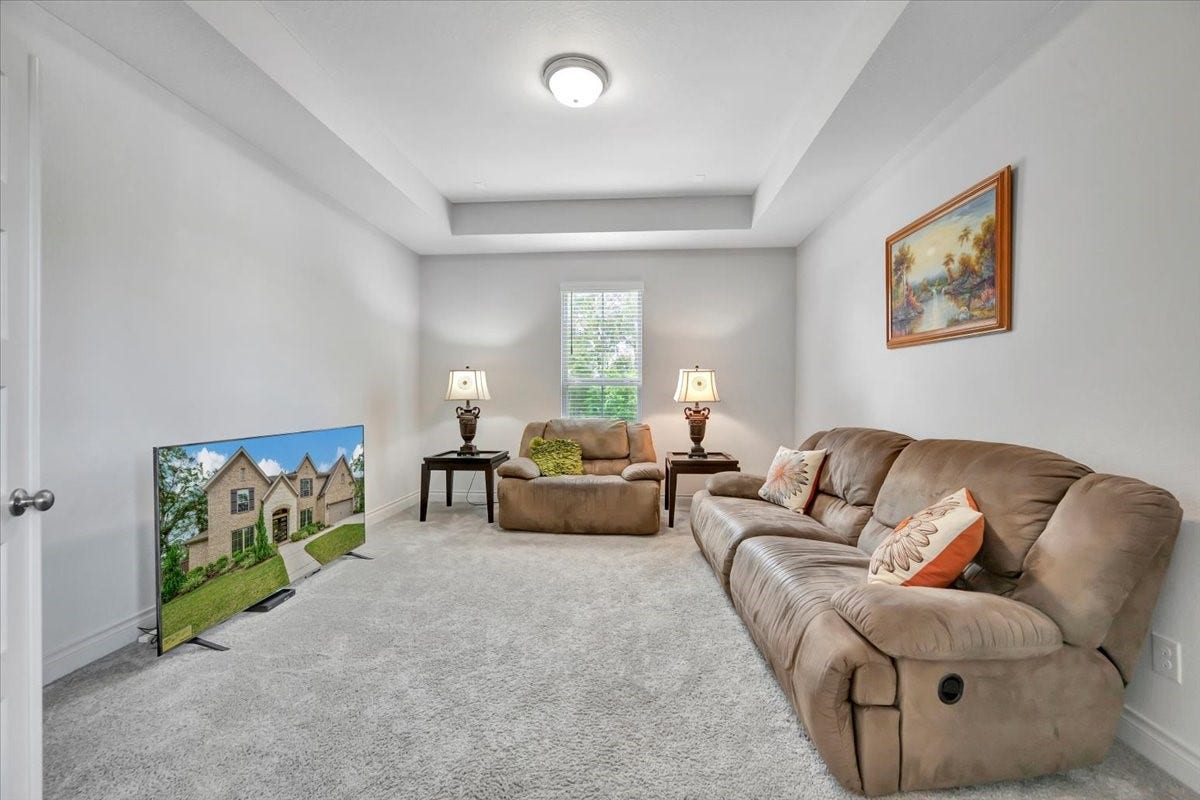 12218 Hickory Arroyo Drive, Humble, TX 77346 Indulge in ultimate relaxation and entertainment in this inviting media room, featuring plush seating and ambient lighting for the perfect movie night experience.