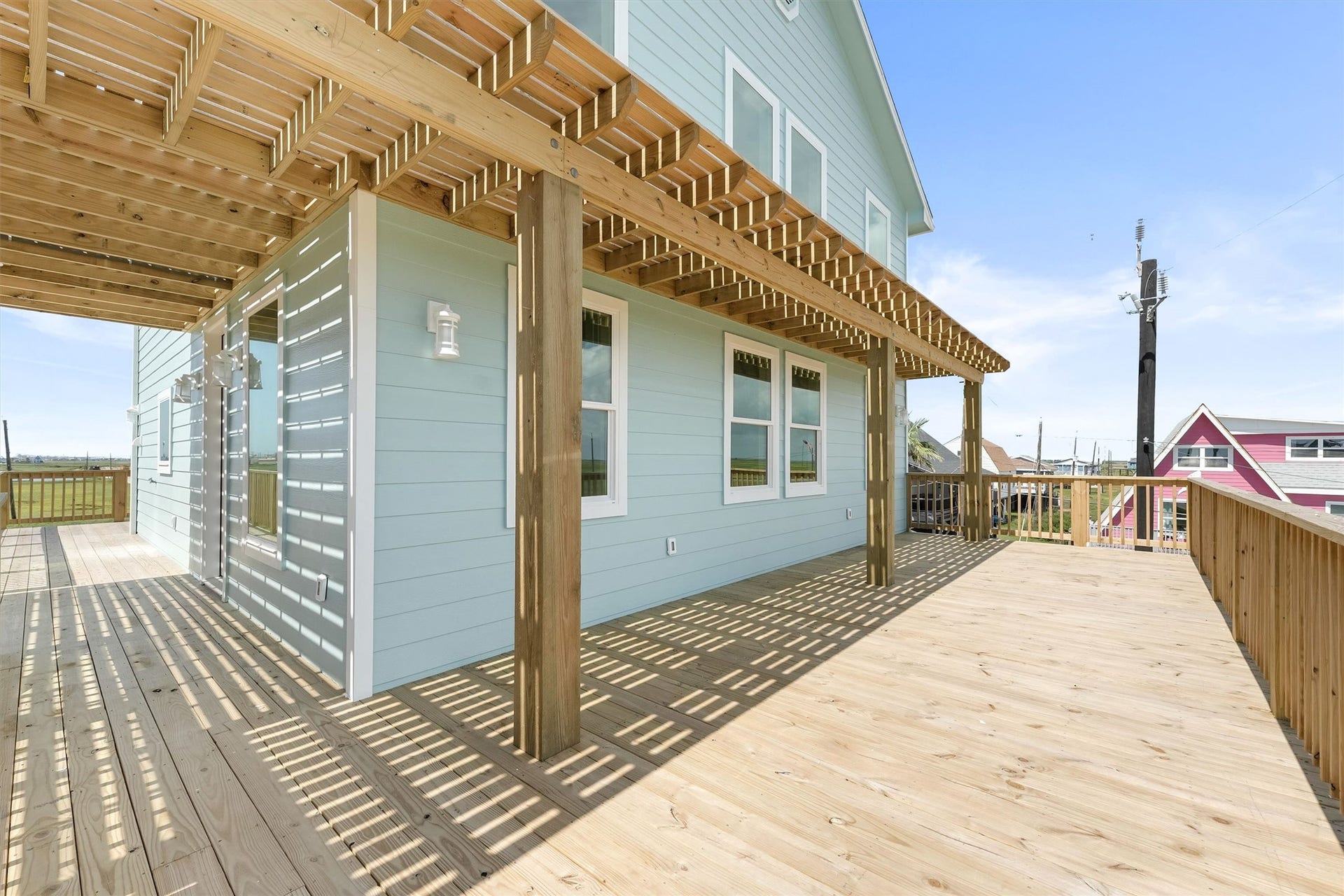 Partially shaded, spacious deck with long-range views of the wetlands, ICW, beach, and bay.