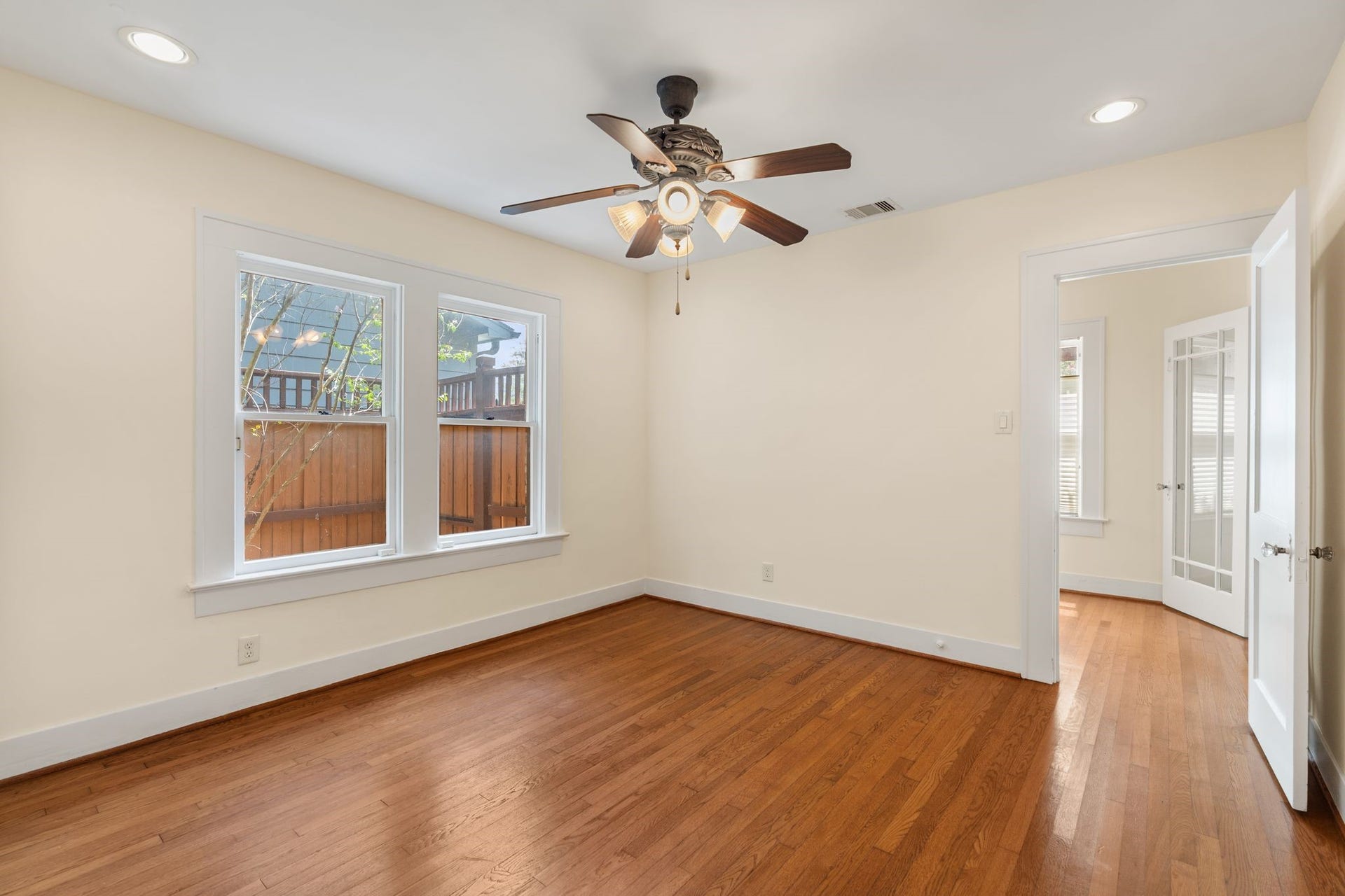 Bedroom # 2 on the first floor features wood floors and recessed lighting.