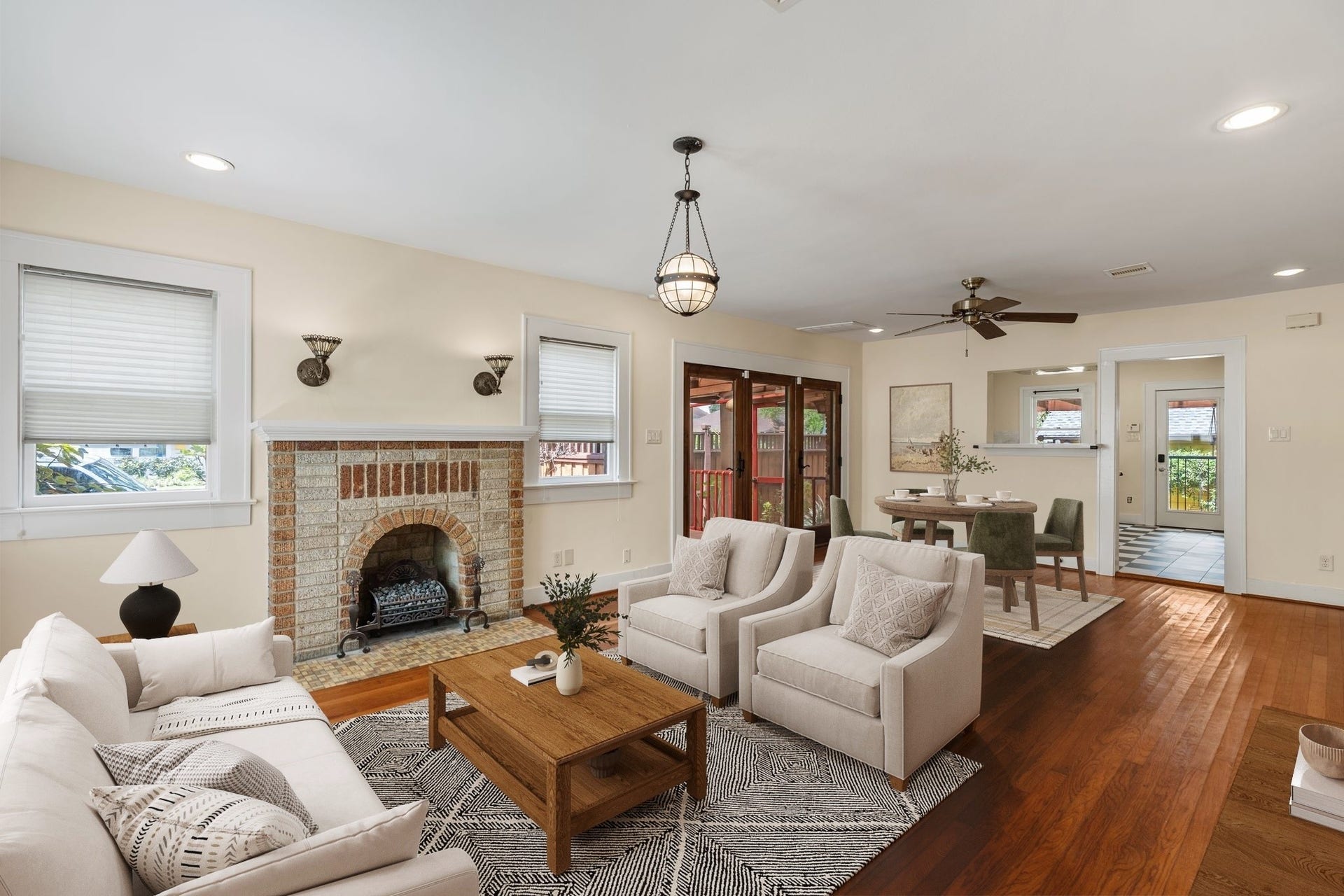 The living room flows seamlessly into the dining space and kitchen and is the perfect space to relax with your family or watch the big game.  Virtually staged.