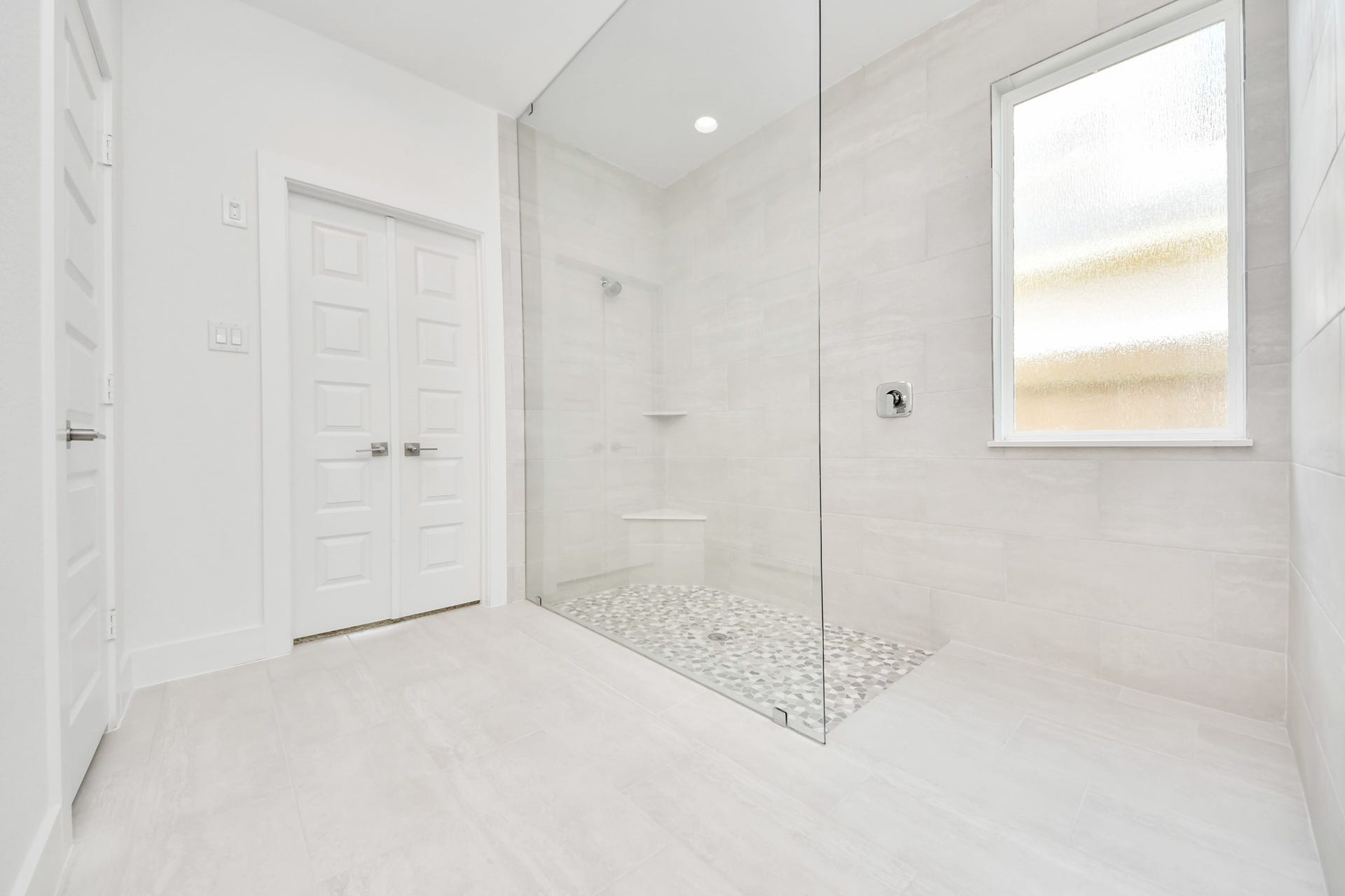 3221 Skerne Spring Drive, Spring, TX 77373 Indulge in a spa-like retreat within the confines of this primary bathroom. Delight in a spacious walk-in shower enveloped in stylish tile surround. Sample photo of completed home with similar floor plan. Actual colors and selections may vary.