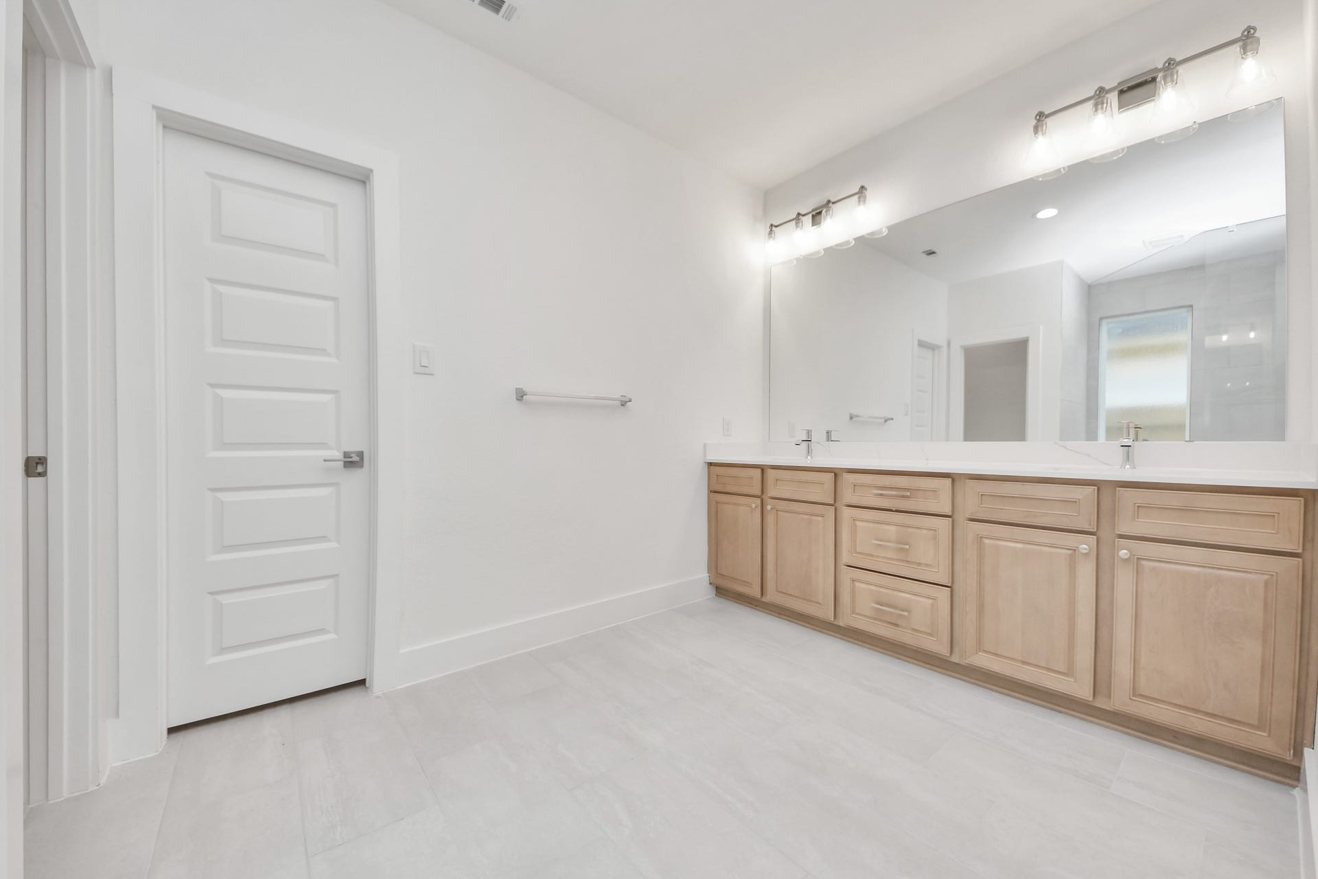3221 Skerne Spring Drive, Spring, TX 77373 Elevate your daily routine at the elegant vanity, now equipped with double sinks, light countertops, modern hardware, and beautiful vanity lights. Sample photo of completed home with similar floor plan. Actual colors and selections may vary.