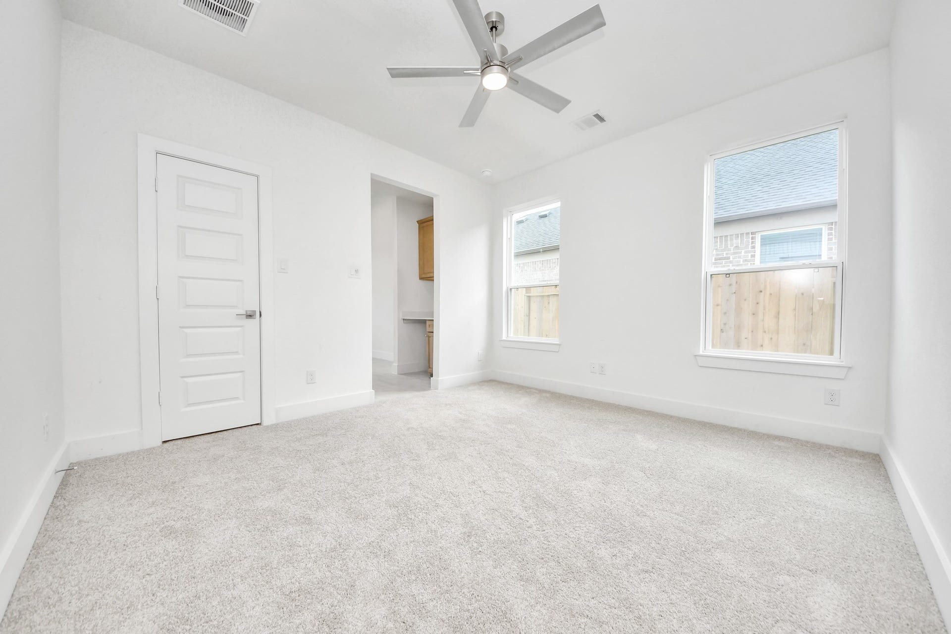3221 Skerne Spring Drive, Spring, TX 77373 Secondary bedroom features plush carpeting, large windows that let in plenty of natural light, bright paint, and spacious closets. Sample photo of completed home with similar floor plan. Actual colors and selections may vary.