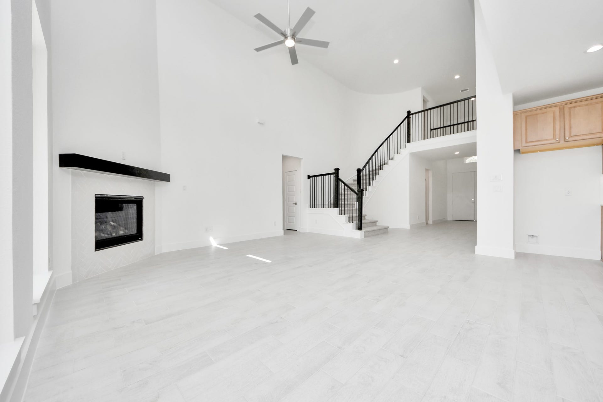 3221 Skerne Spring Drive, Spring, TX 77373 Family room flooded with natural light through the expansive windows. The premium tile flooring adds a touch of luxury to the space, creating the perfect setting for relaxing moments and cherished gatherings with loved ones. Sample photo of completed home with similar floor plan. Actual colors and selections may vary.