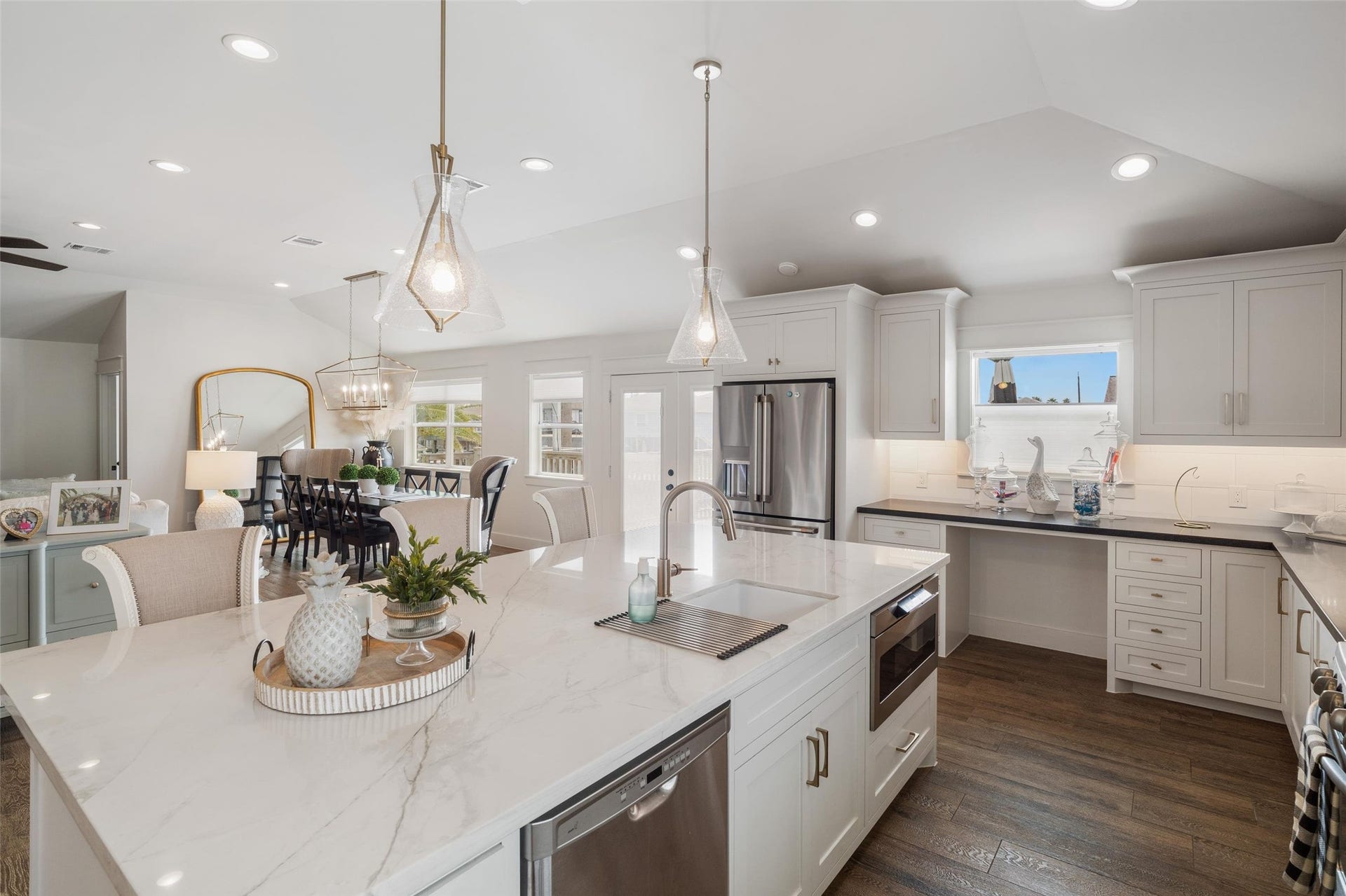 276 Barracuda Street, Bayou Vista, TX 77563 Spacious kitchen island with custom modern pendant lighting, overlooking the open dining and living rooms.