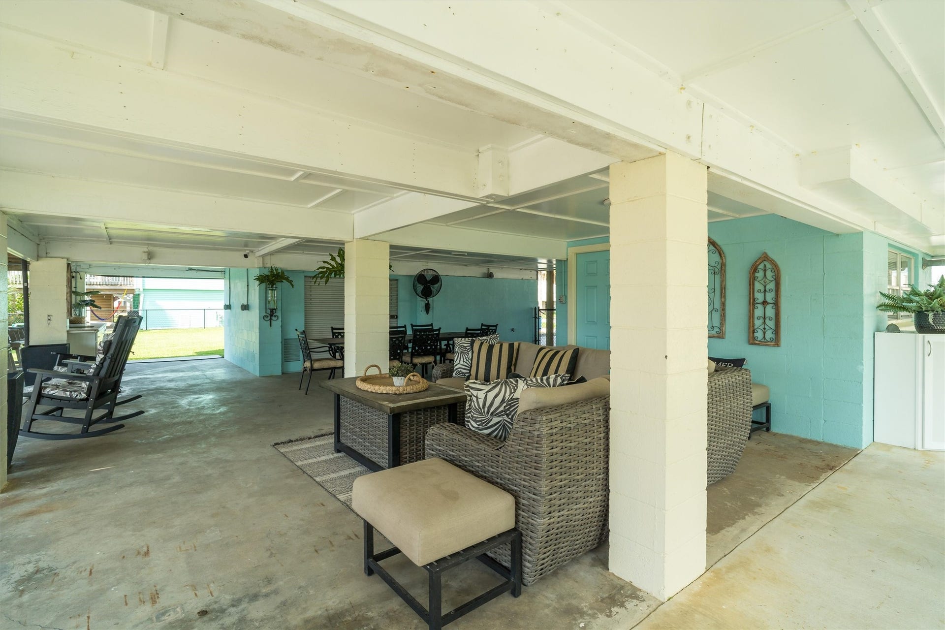 276 Barracuda Street, Bayou Vista, TX 77563 The downstairs features a shady entertaining area, perfect for relaxing out of the sun, along with an open space ideal for gatherings, games, or enjoying the fresh air. This versatile setup offers options for both cool comfort and outdoor fun
