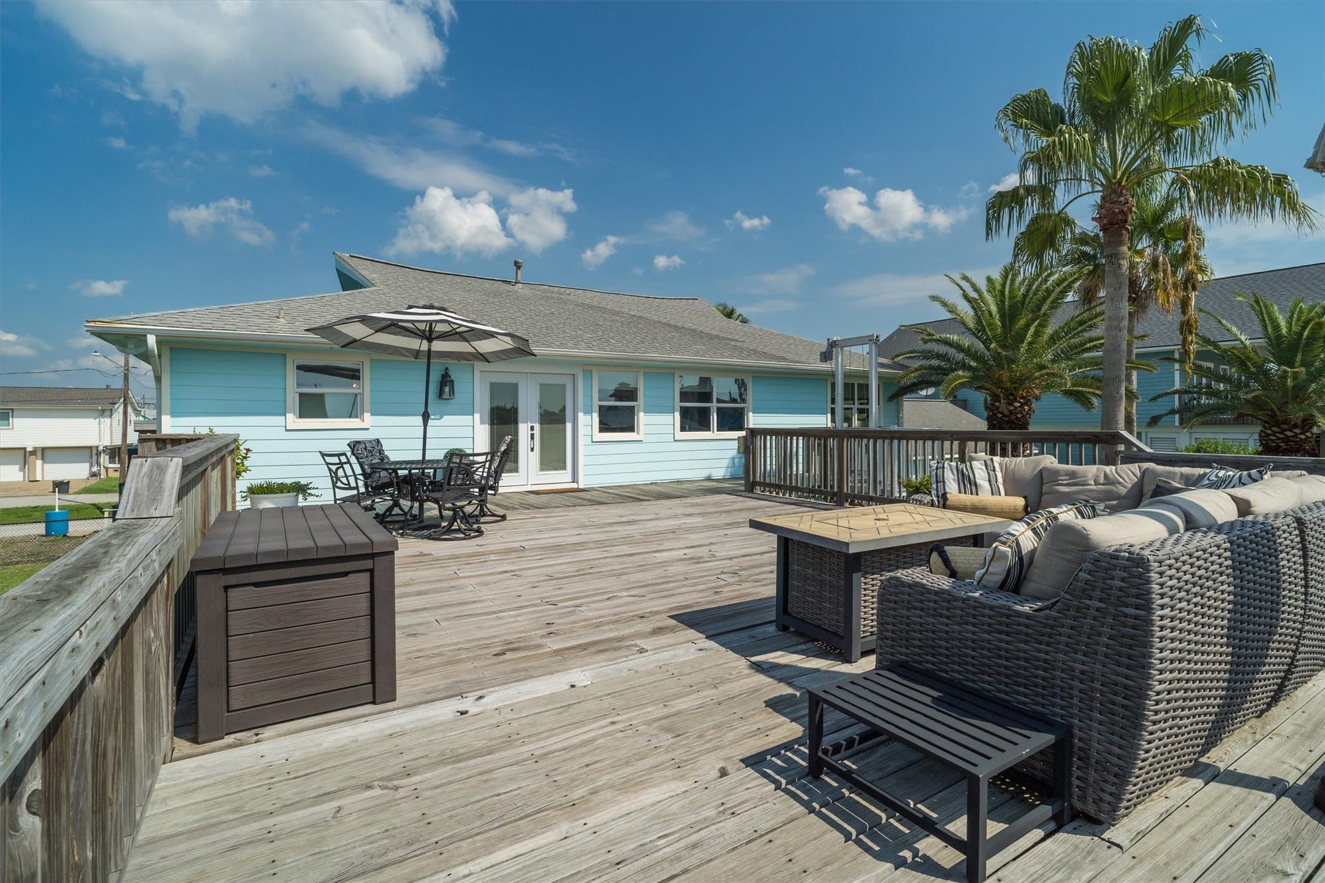 276 Barracuda Street, Bayou Vista, TX 77563 This expansive upper party deck is perfect for outdoor dining, lounging, or hosting memorable celebrations, providing a versatile space that truly enhances the home's appeal