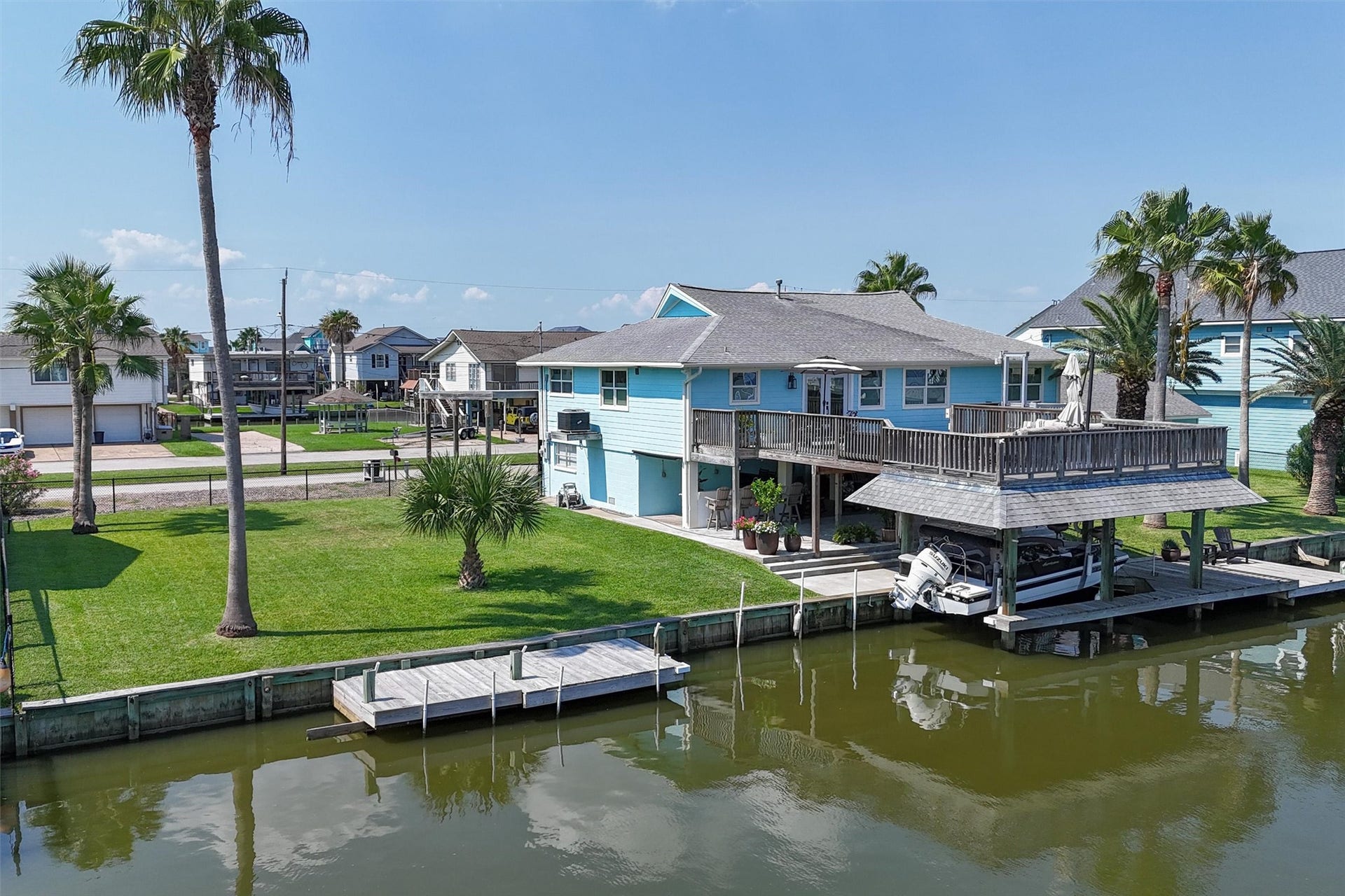 276 Barracuda Street, Bayou Vista, TX 77563 Aerial view showing the extra lot with palm trees. There's even an additional dock on the lot