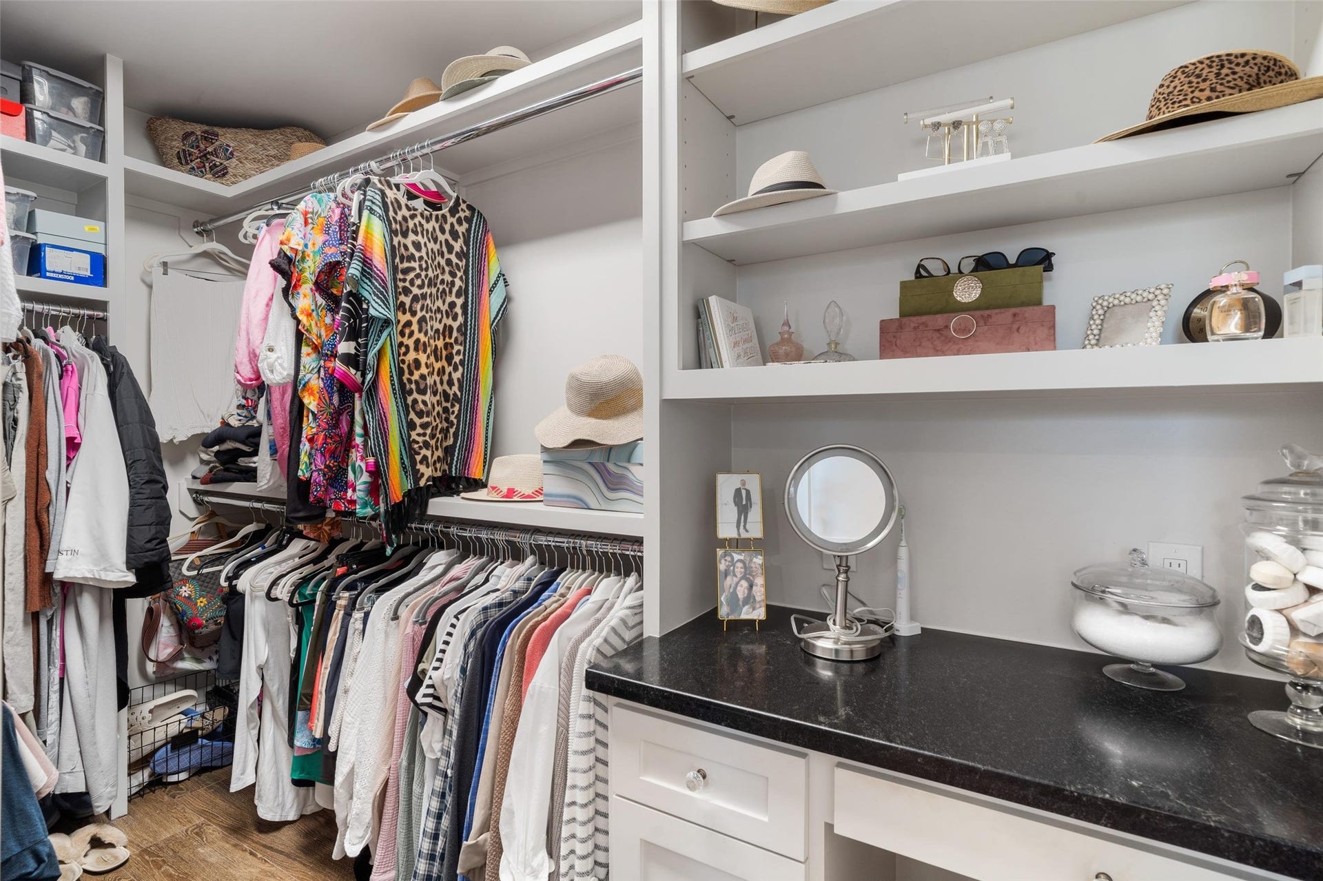 276 Barracuda Street, Bayou Vista, TX 77563 Expansive primary walk-in closet with custom built-ins and a beautifully designed makeup vanity, offering both elegance and functionality for organized, everyday living