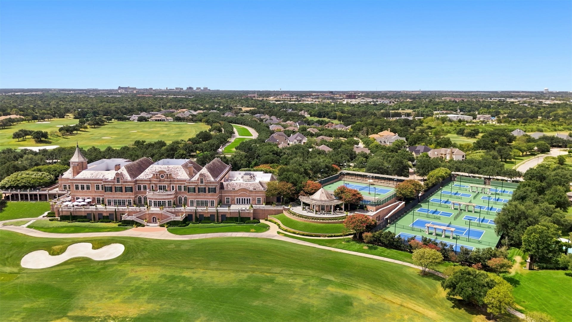 5117 Inverness Drive, Bryan, TX 77802 Aerial view of Miramont Country Club featuring the clubhouse, championship golf course, tennis courts, and pickleball courts.