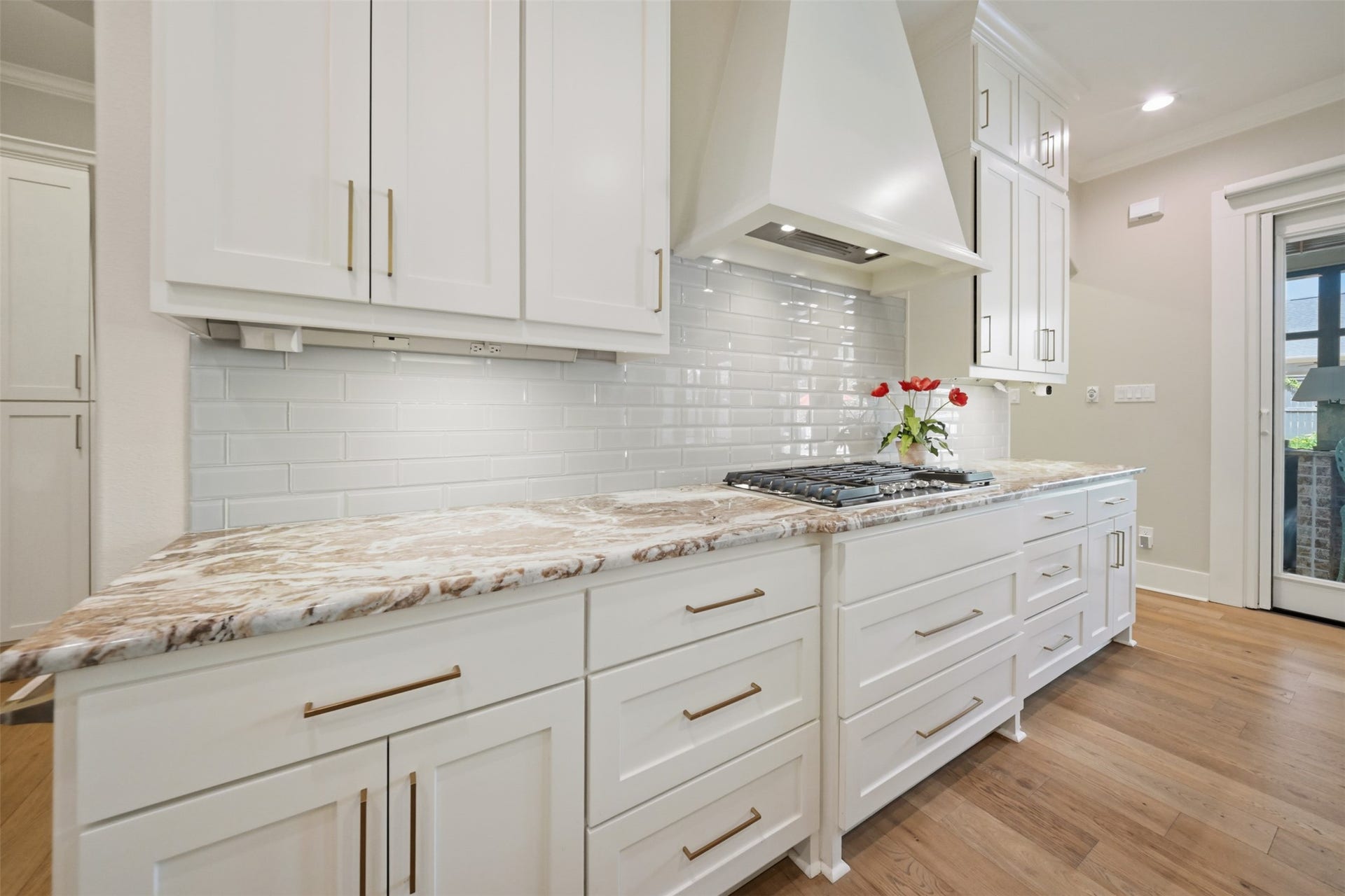 5117 Inverness Drive, Bryan, TX 77802 Beautifully appointed kitchen with custom vent hood, 5 burner gas cooktop and abundant custom cabinetry.