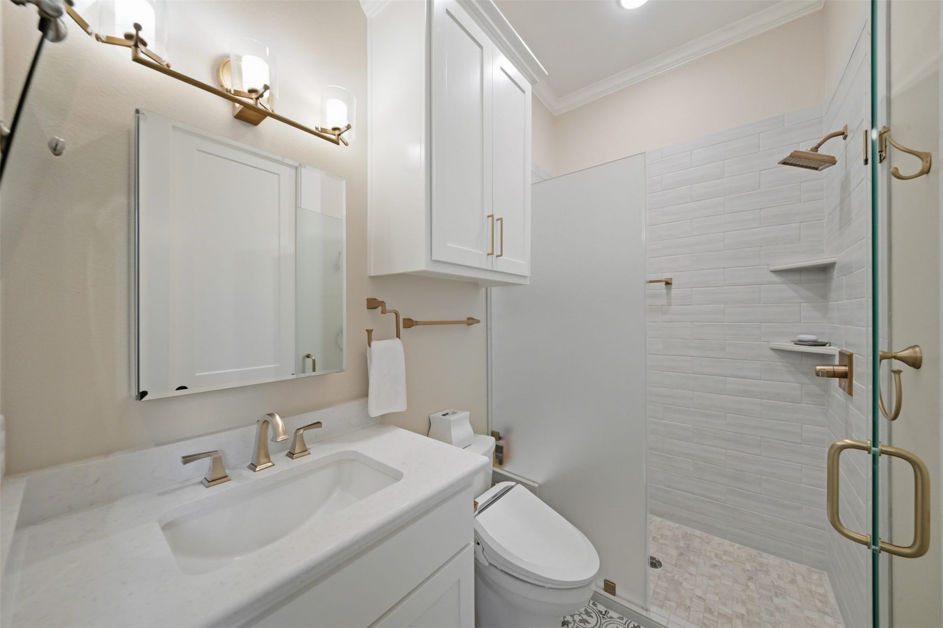 5117 Inverness Drive, Bryan, TX 77802 Secondary en suite bath with custom cabinetry, walk-in shower and adjoining walk-in closet.