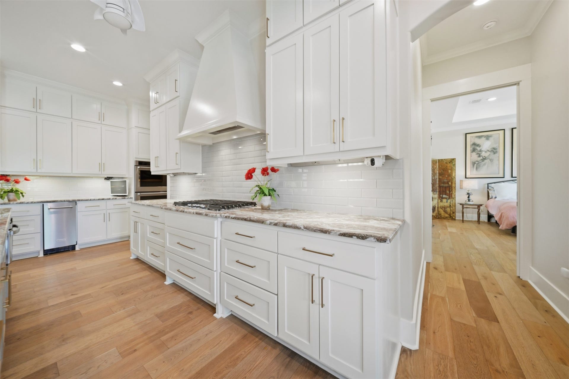 5117 Inverness Drive, Bryan, TX 77802 Beautifully appointed kitchen featuring a gas cooktop, custom vent hood, marble countertops, and abundant custom cabinetry.