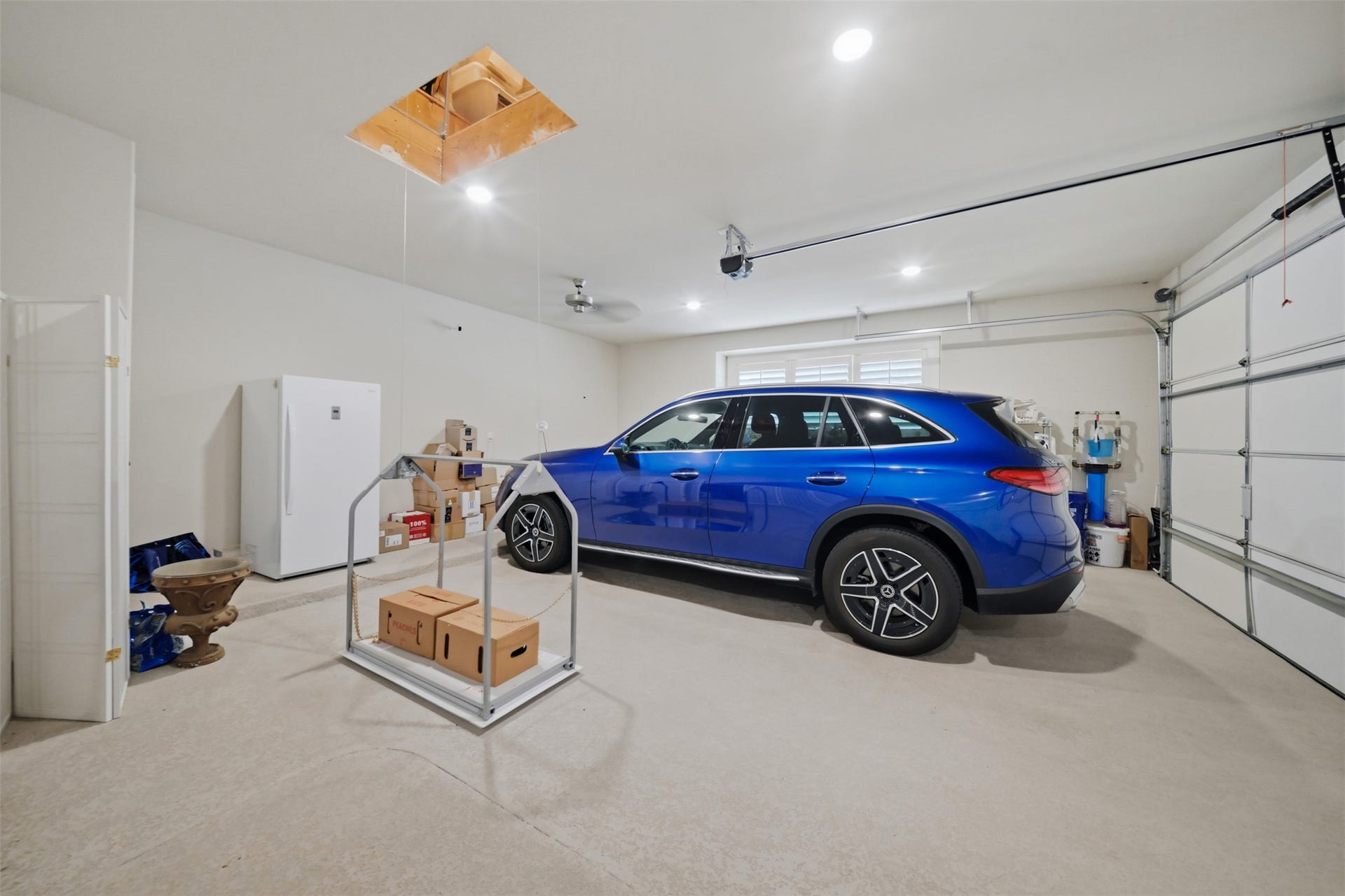 5117 Inverness Drive, Bryan, TX 77802 Versa Lift provides convenient access for moving items between the garage and attic storage.