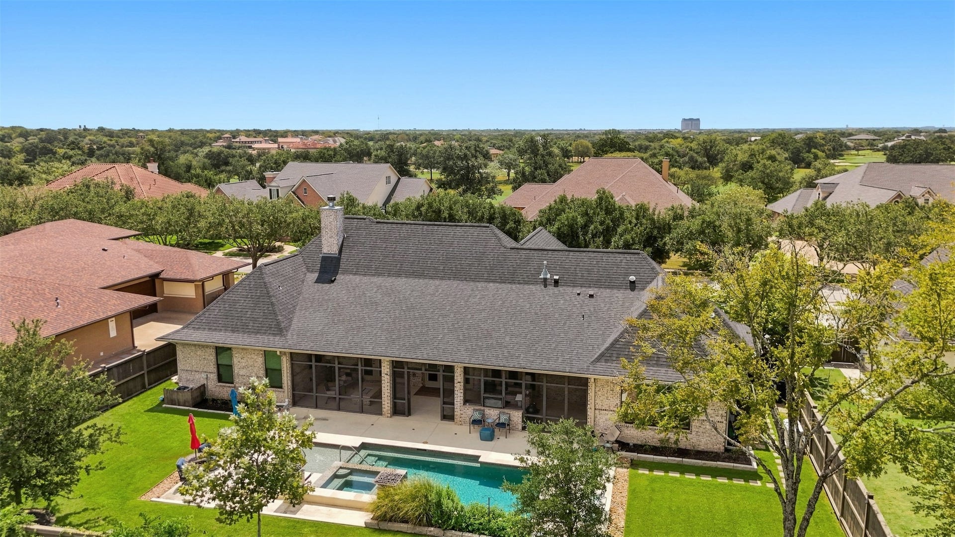 5117 Inverness Drive, Bryan, TX 77802 Pool and patio area offering multiple spaces for lounging, dining, and relaxing, with the screened porch just steps away.