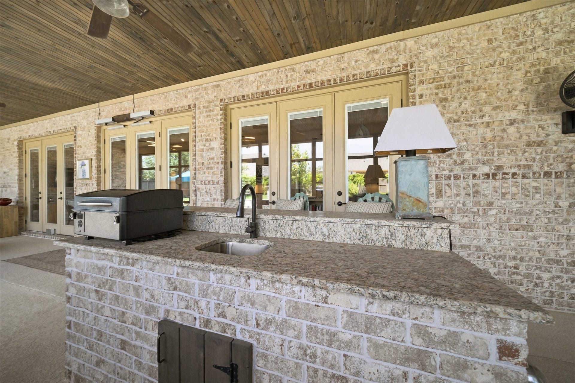 5117 Inverness Drive, Bryan, TX 77802 Screened-in patio features a built-in outdoor kitchen with grill, sink and generous counter space overlooking the backyard and pool.